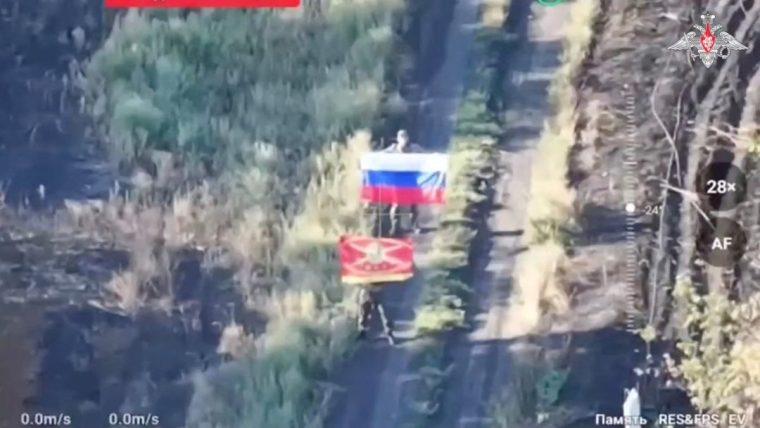 A still image, taken from footage released by the Russian Defence Ministry, shows what it said to be Russian soldiers displaying flags, following the capture of Ukraine's settlement of Zaporizke in the Dnipropetrovsk region, in the course of Russia-Ukraine military conflict, in this image from video released August 25, 2025. Russian Defence Ministry/Handout via REUTERS ATTENTION EDITORS - THIS IMAGE HAS BEEN SUPPLIED BY A THIRD PARTY. NO RESALES. NO ARCHIVES. MANDATORY CREDIT. BEST QUALITY AVAILABLE. ONSCREEN TEXT AND LOGO FROM SOURCE. Verification lines: - Reuters was able to independently verify the location with the position of the buildings, the roads and terrain layout that matched the file and satellite imagery of the area.