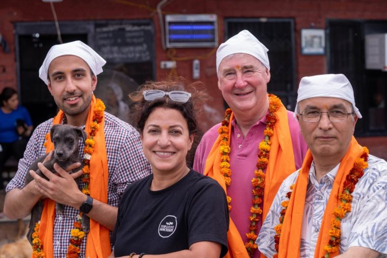 Rohin holding a puppy, Amita, Peter and Harmesh at the Pawsitive dog sanctuary