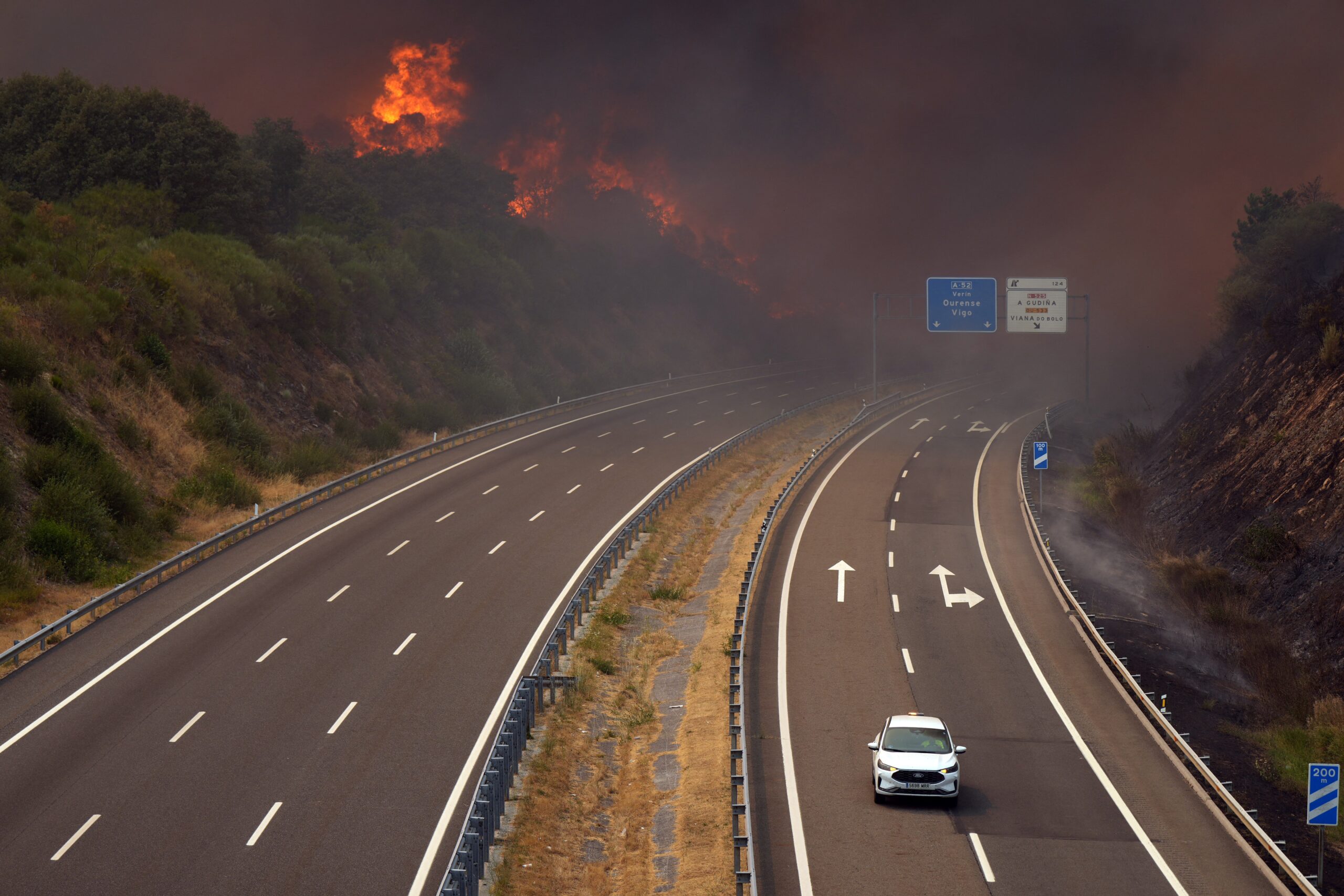 A wildfire burns near a highway in Spain last week. European nations across the continent have grappled with high heats this summer