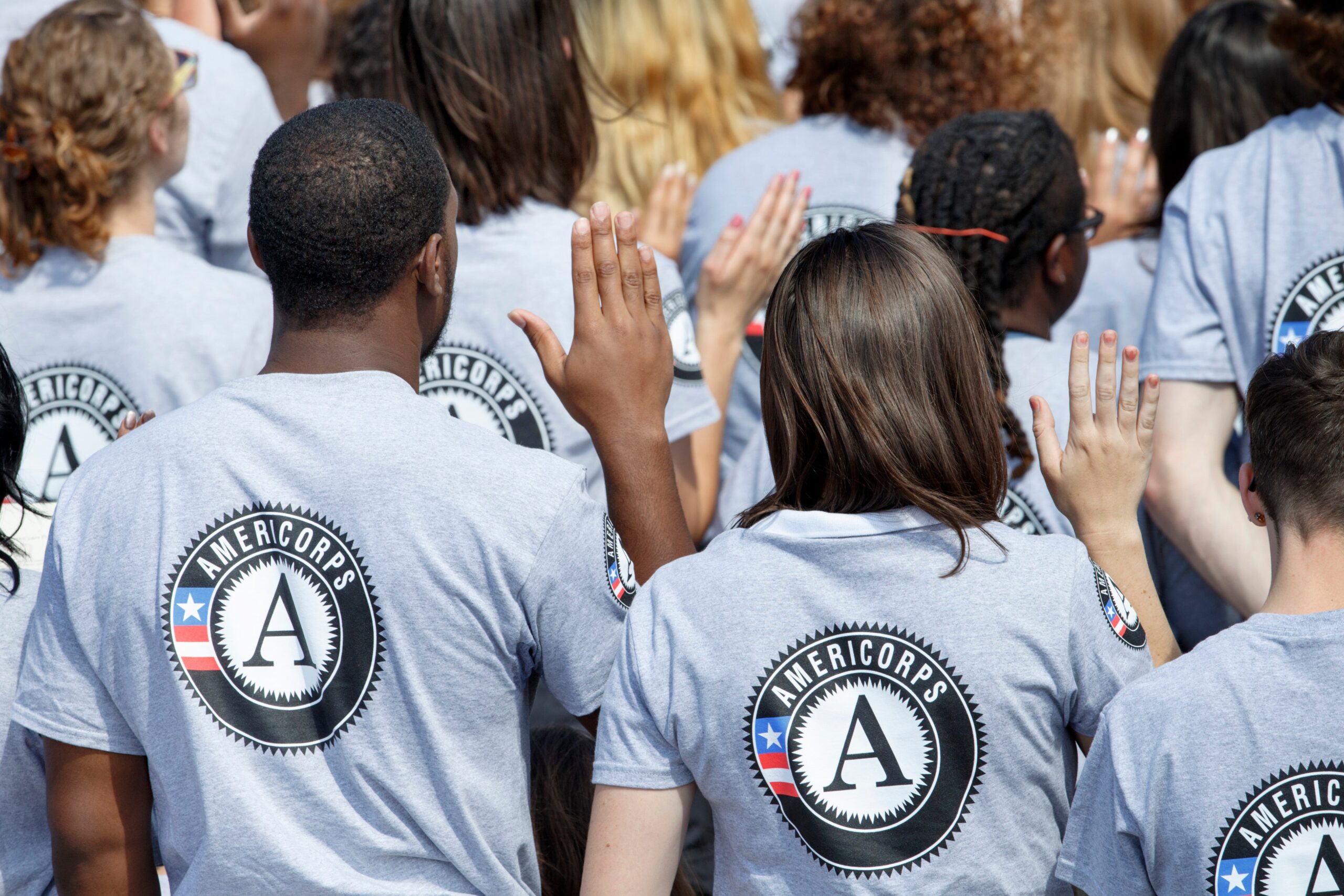 AmeriCorps volunteers during a swearing-in ceremony. The White House Office of Management and Budget confirmed that it would release $184 million in funding for the federal program after the Trump administration froze it earlier in 2025
