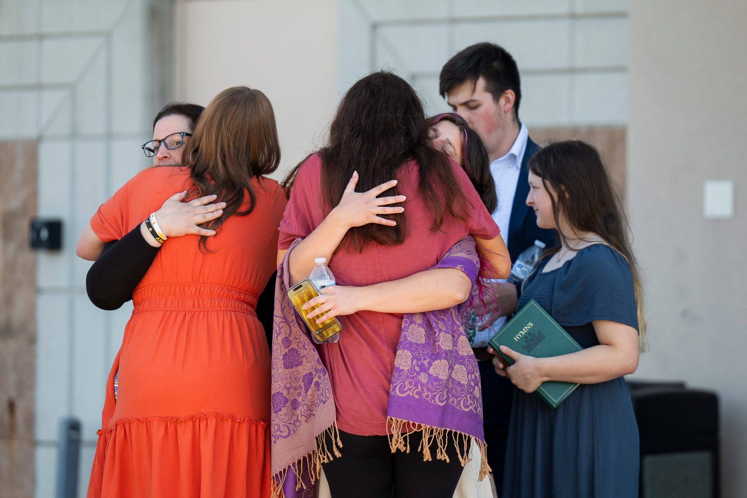 People are reunited at Trillium NCG Theatre with friends and family who were present during a nearby shooting
