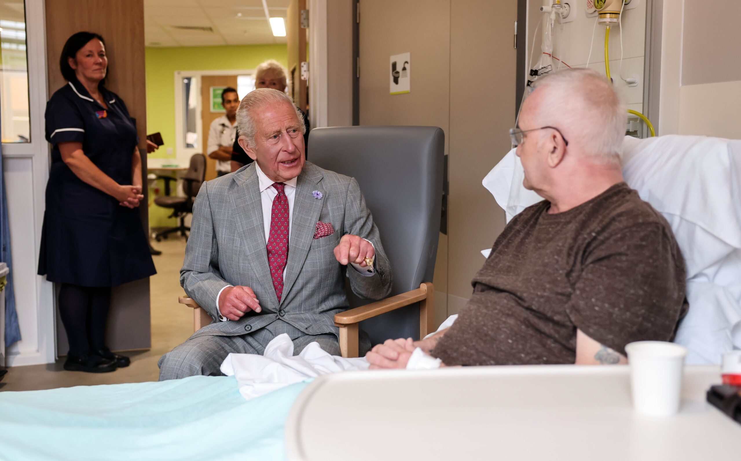 King Charles III talks with patient Phillip Barnard during his visit to officially open the new Midland Metropolitan University Hospital in Birmingham