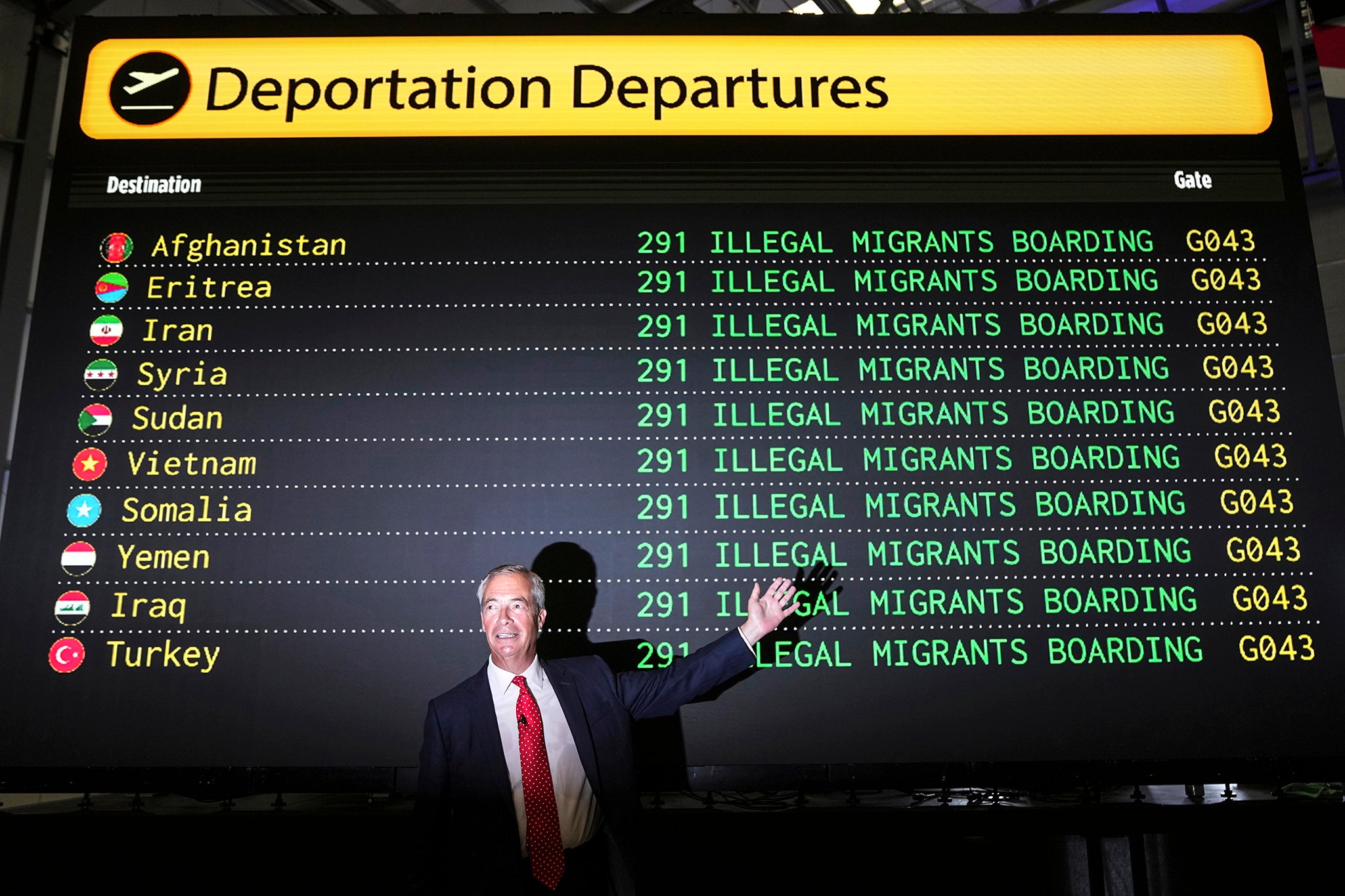 Reform party leader Nigel Farage poses in front of a mock departures board during a press conference in a hangar at Oxford Airport in Kidlington last week