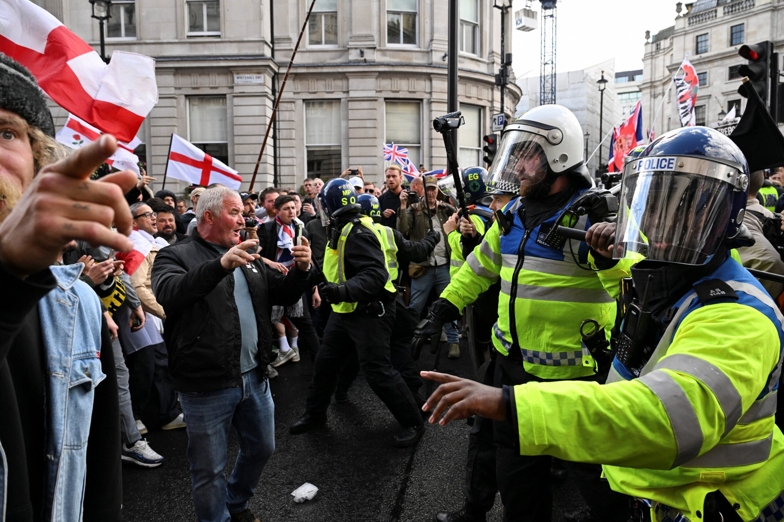 Police officers confront supporters of Tommy Robinson on Saturday