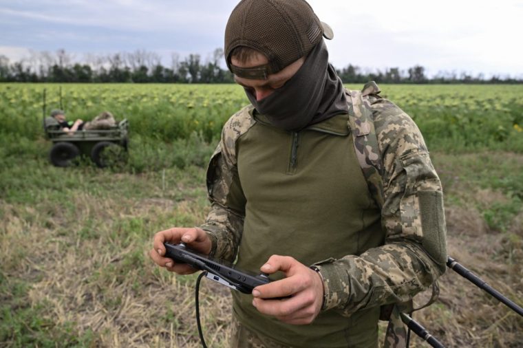 A Ukrainian serviceman, 27, with call sign Crop from the 5th Separate Assault Brigade, controls an unmanned ground vehicle during a demonstration of its capabilities on a training ground at an undisclosed location in eastern Ukraine on August 11, 2025, amid the Russian invasion of Ukraine. The proliferation of cheap but deadly drones deployed by Russian and Ukrainian forces has irreversibly changed how the war is being waged -- forcing military medics to find new ways to retrieve wounded to field hospitals for treatment, including by robot. (Photo by Genya SAVILOV / AFP) (Photo by GENYA SAVILOV/AFP via Getty Images)