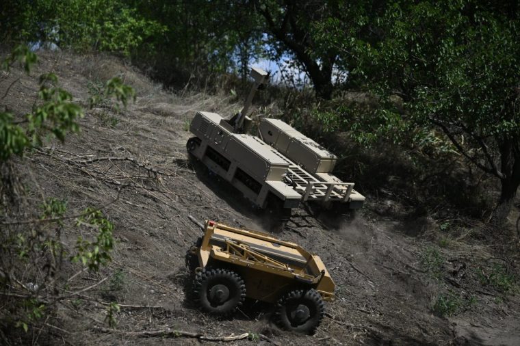 This photograph shows unmanned ground vehicles of the 93rd Separate Mechanized Brigade rolling on a training ground at an undisclosed location in eastern Ukraine on August 13, 2025, amid the Russian invasion of Ukraine. The proliferation of cheap but deadly drones deployed by Russian and Ukrainian forces has irreversibly changed how the war is being waged -- forcing military medics to find new ways to retrieve wounded to field hospitals for treatment, including by robot. (Photo by Genya SAVILOV / AFP) (Photo by GENYA SAVILOV/AFP via Getty Images)
