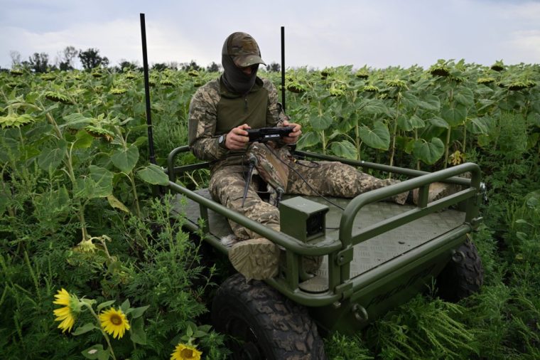 A Ukrainian serviceman, 27, with call sign Crop from the 5th Separate Assault Brigade, controls an unmanned ground vehicle during a demonstration of its capabilities on a training ground at an undisclosed location in eastern Ukraine on August 11, 2025, amid the Russian invasion of Ukraine. The proliferation of cheap but deadly drones deployed by Russian and Ukrainian forces has irreversibly changed how the war is being waged -- forcing military medics to find new ways to retrieve wounded to field hospitals for treatment, including by robot. (Photo by Genya SAVILOV / AFP) (Photo by GENYA SAVILOV/AFP via Getty Images)
