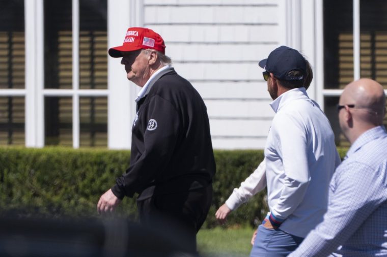 President Donald Trump, left, walks toward the tennis court at the Trump National Golf Club in Sterling, Va., Saturday, Aug. 30, 2025. (AP Photo/Manuel Balce Ceneta)