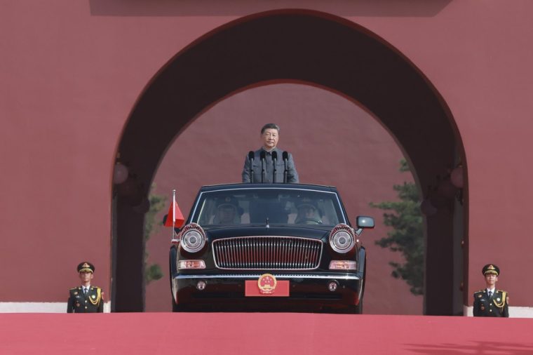 In this photo provided by Xinhua News Agency, Chinese President Xi Jinping is ready to review troops as a Hongqi limousine carrying him drives out of the Tiananmen Rostrum during a ceremony to commemorate the 80th anniversary of Japan's World War II surrender in Beijing, China, Tuesday, Sept. 3, 2025. (Wang Ye/Xinhua News Agency via AP)