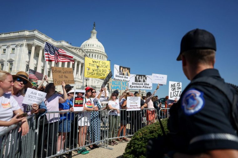 People hold signs on the day of a rally in support of victims of late financier Jeffrey Epstein, on Capitol Hill in Washington, D.C., U.S., September 3, 2025. REUTERS/Evelyn Hockstein