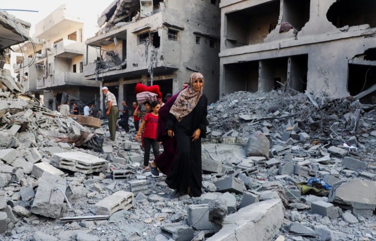 Palestinians inspect the site of an overnight Israeli strike on a house in Gaza City, September 16, 2025. REUTERS/Ebrahim Hajjaj