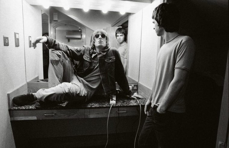 Noel Gallagher (pictured right with Liam at Wembley Stadium in 2000) hated posing for pictures and preferred to let Furmanovsky shoot photos while following the band around (Photo: Jill Furmanovsky)