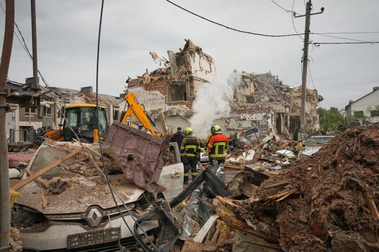 Rescuers work at the site of an apartment buildings damaged during a Russian attack in Kyiv, Ukraine, Sunday, Sept. 28, 2025. (AP Photo/Efrem Lukatsky)