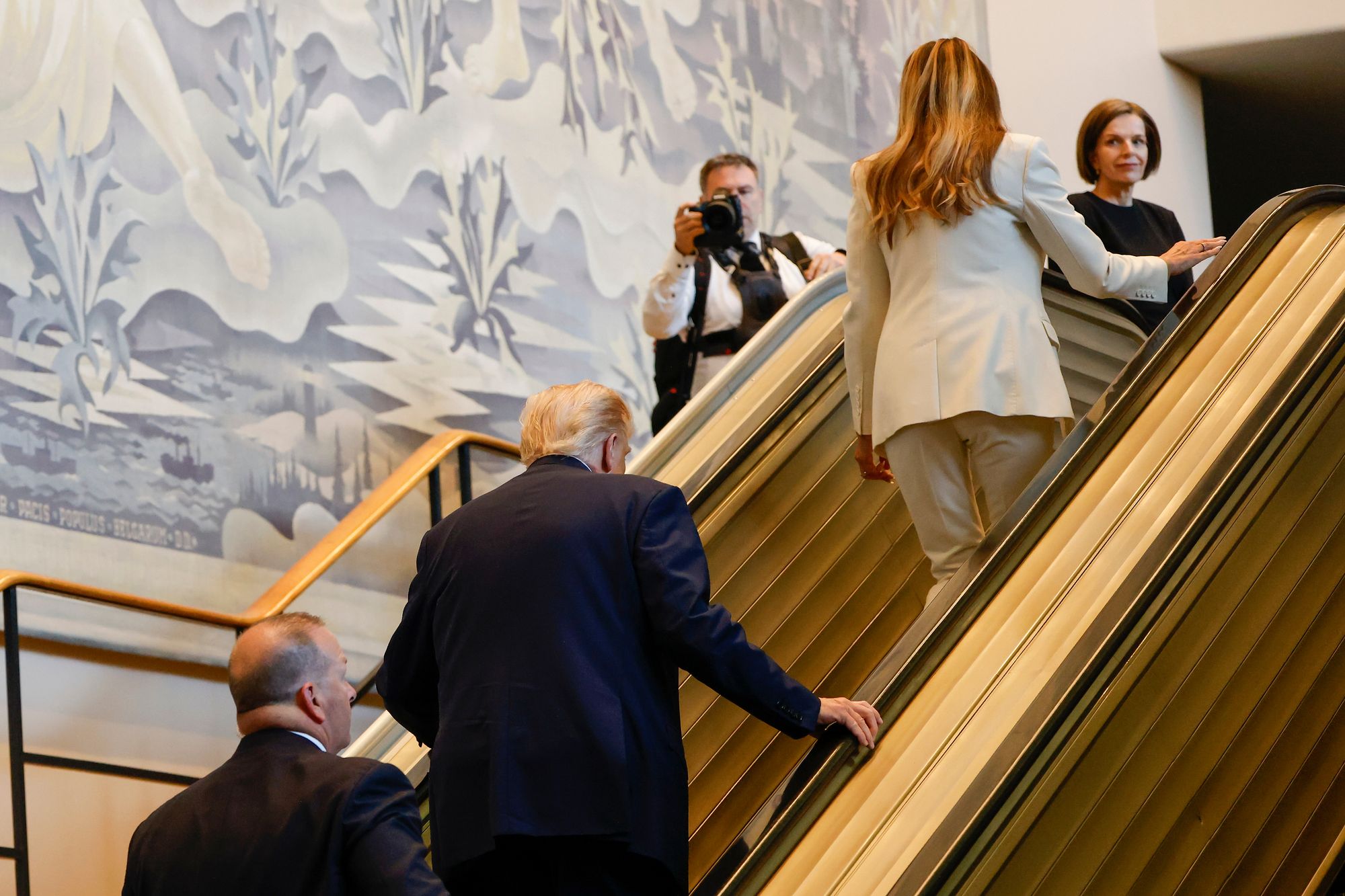 A new clip from Governor Gavin Newsom splices together soundbites from Trump with footage of the stalled escalator he and First Lady Melania Trump attempted to ride last week.
