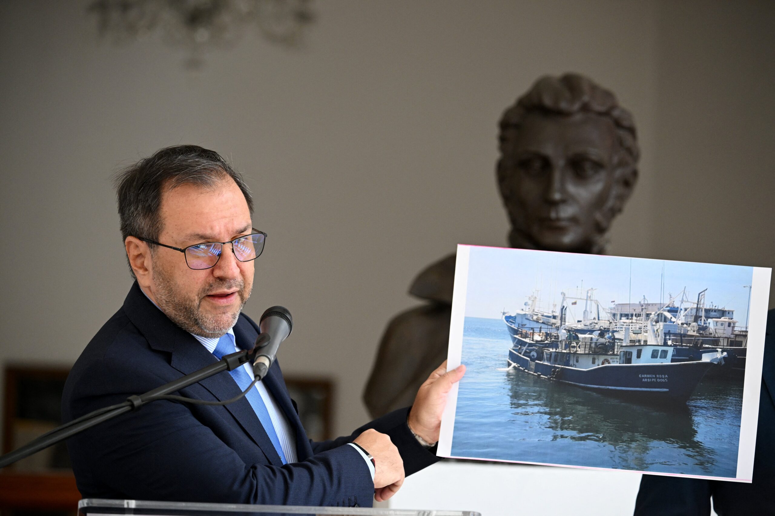Venezuela's Foreign Minister Yvan Gil shows a picture of a fishing boat during a press conference at the Ministry of Foreign Affairs in Caracas September 13. Venezuela on Saturday hit out at the United States for allegedly seizing a fishing boat for eight hours in its exclusive economic zone, as the US military patrols the Caribbean to target drug cartels