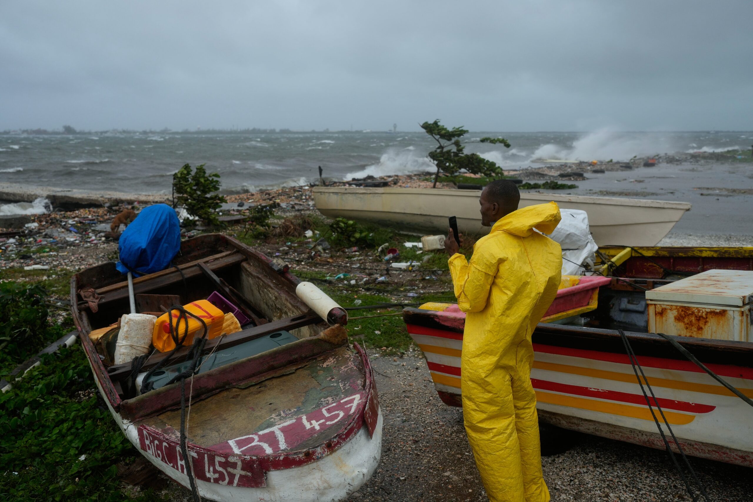 A man watches the coastline in Kingston, Jamaica, as Hurricane Melissa closes in