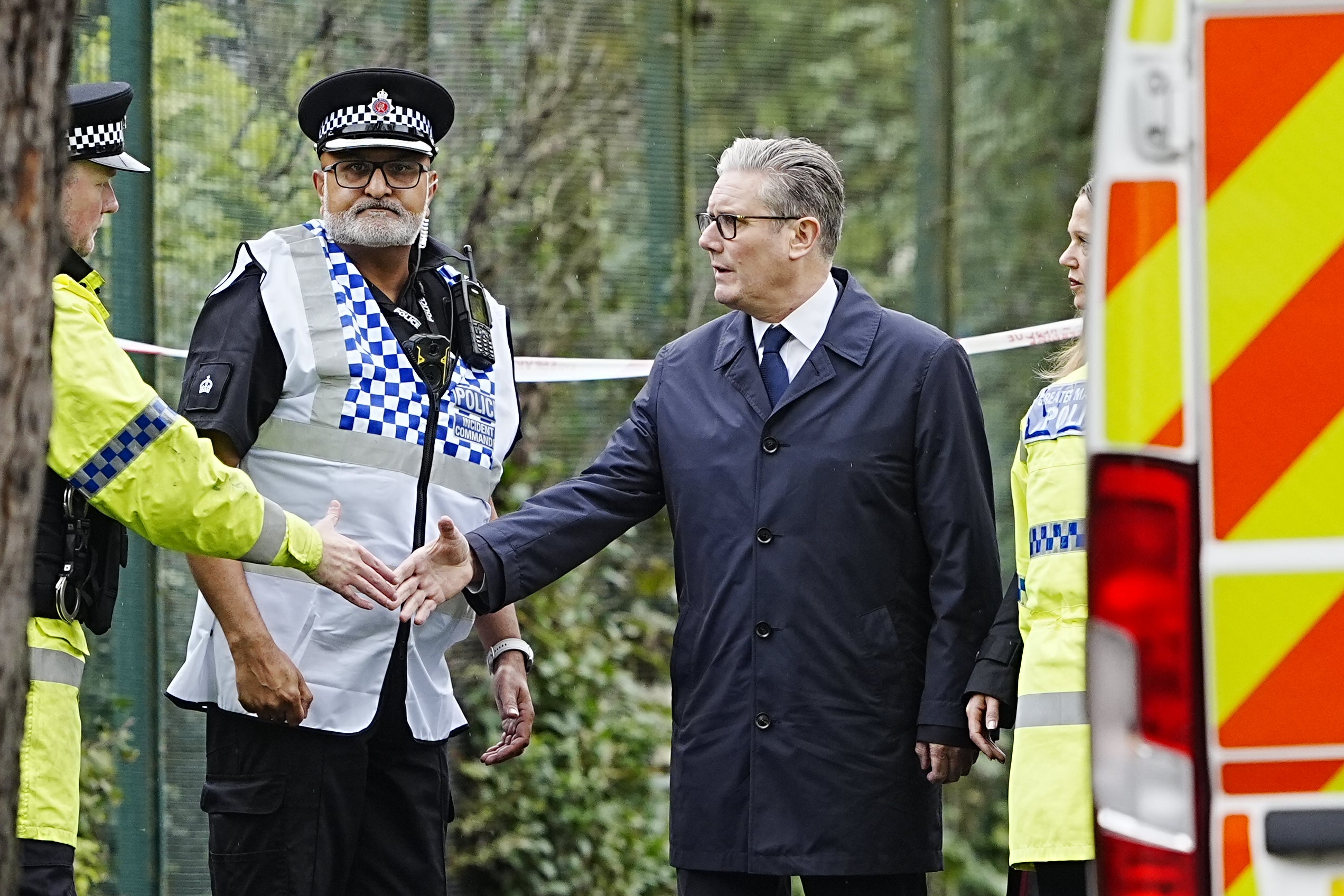 Sir Keir Starmer speaks with emergency responders during a visit to the Heaton Park Hebrew Congregation synagogue