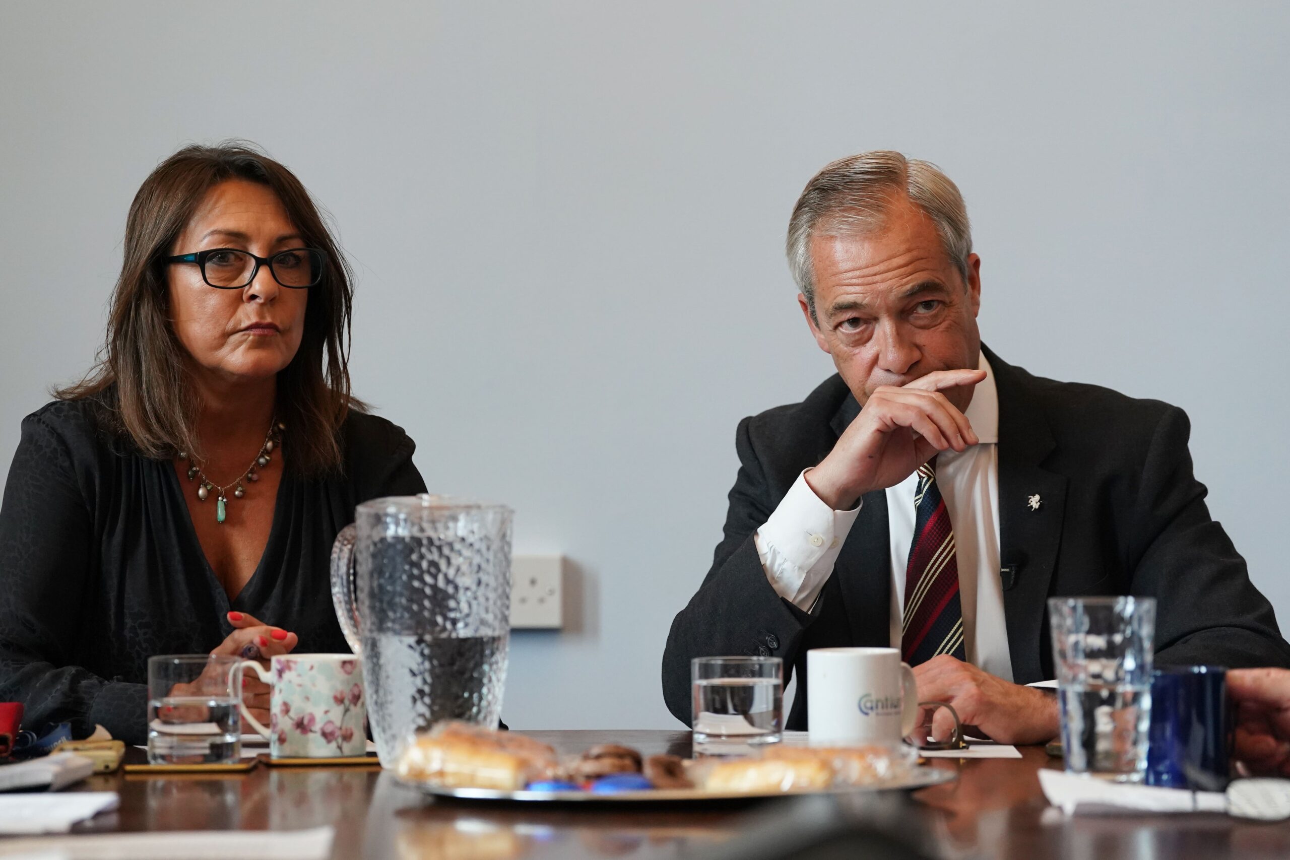 Reform UK leader Nigel Farage attending a meeting alongside the head of Kent County Council, Linden Kemkaran, in July (PA)