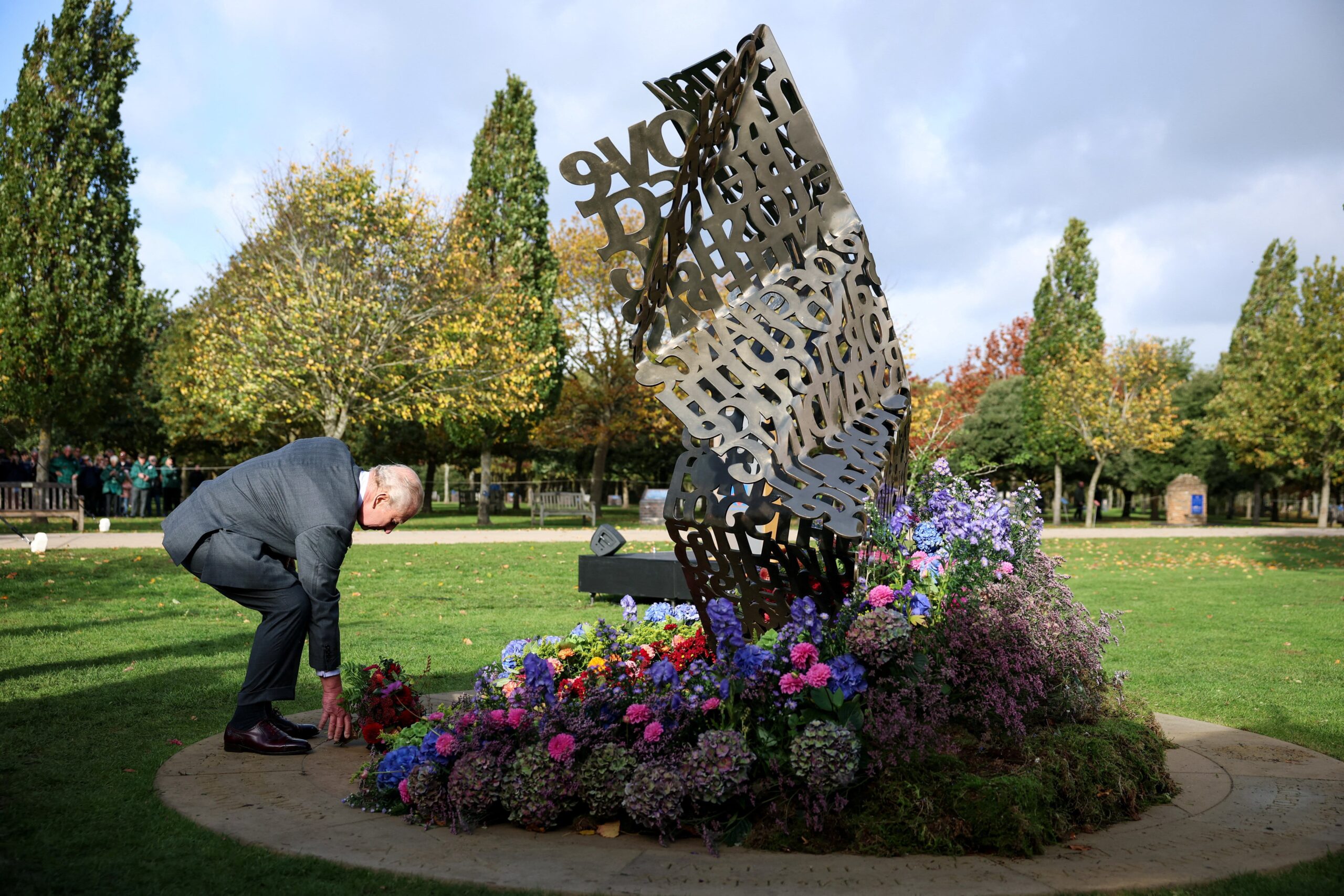 The King lays flowers during the dedication ceremony of the LGBT armed forces memorial (Phil Noble/PA)