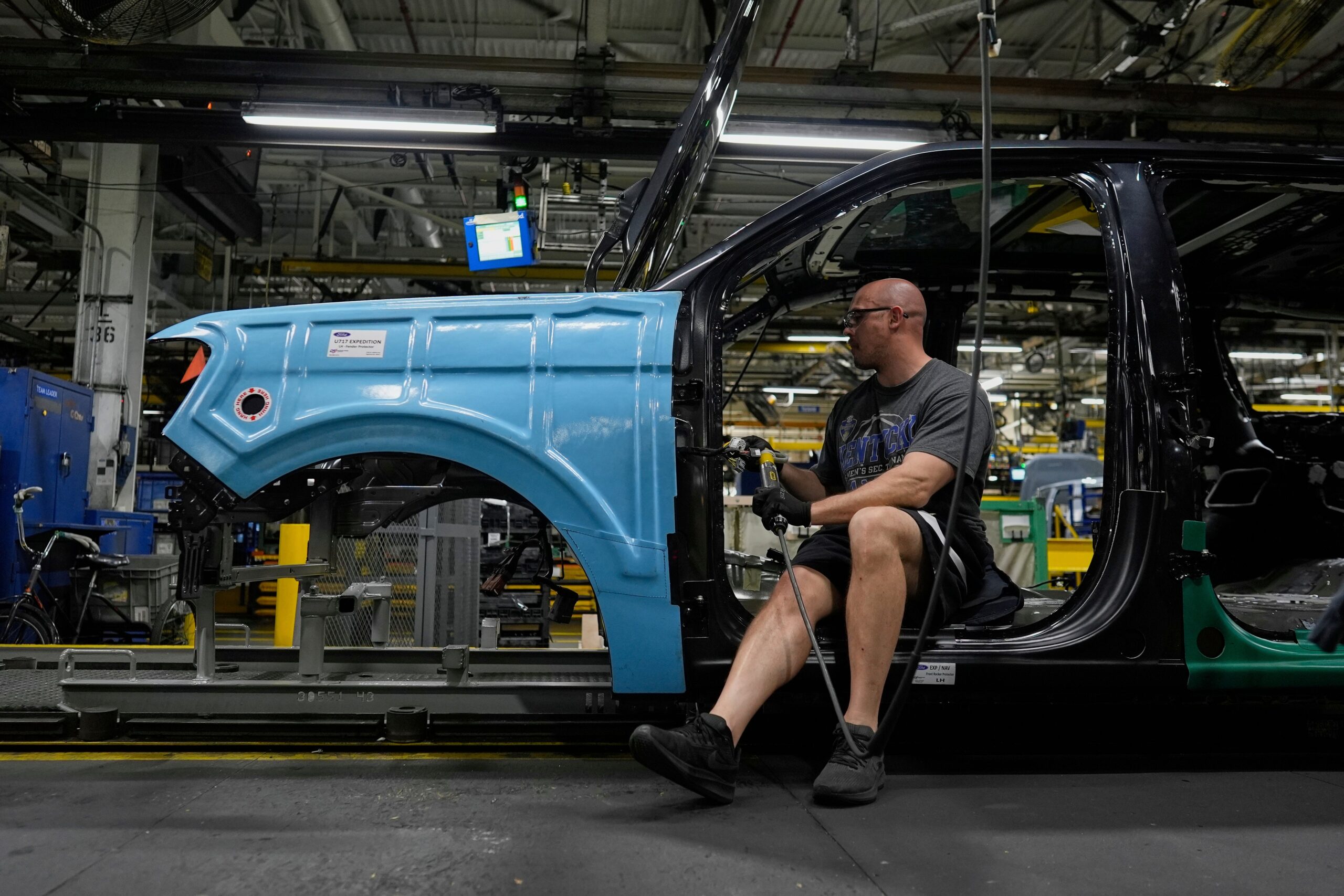 A vehicle assembly technician works on a 2025 Ford Expedition. Ford recalled more than 200,000 vehicles Thursday, citing safety concerns
