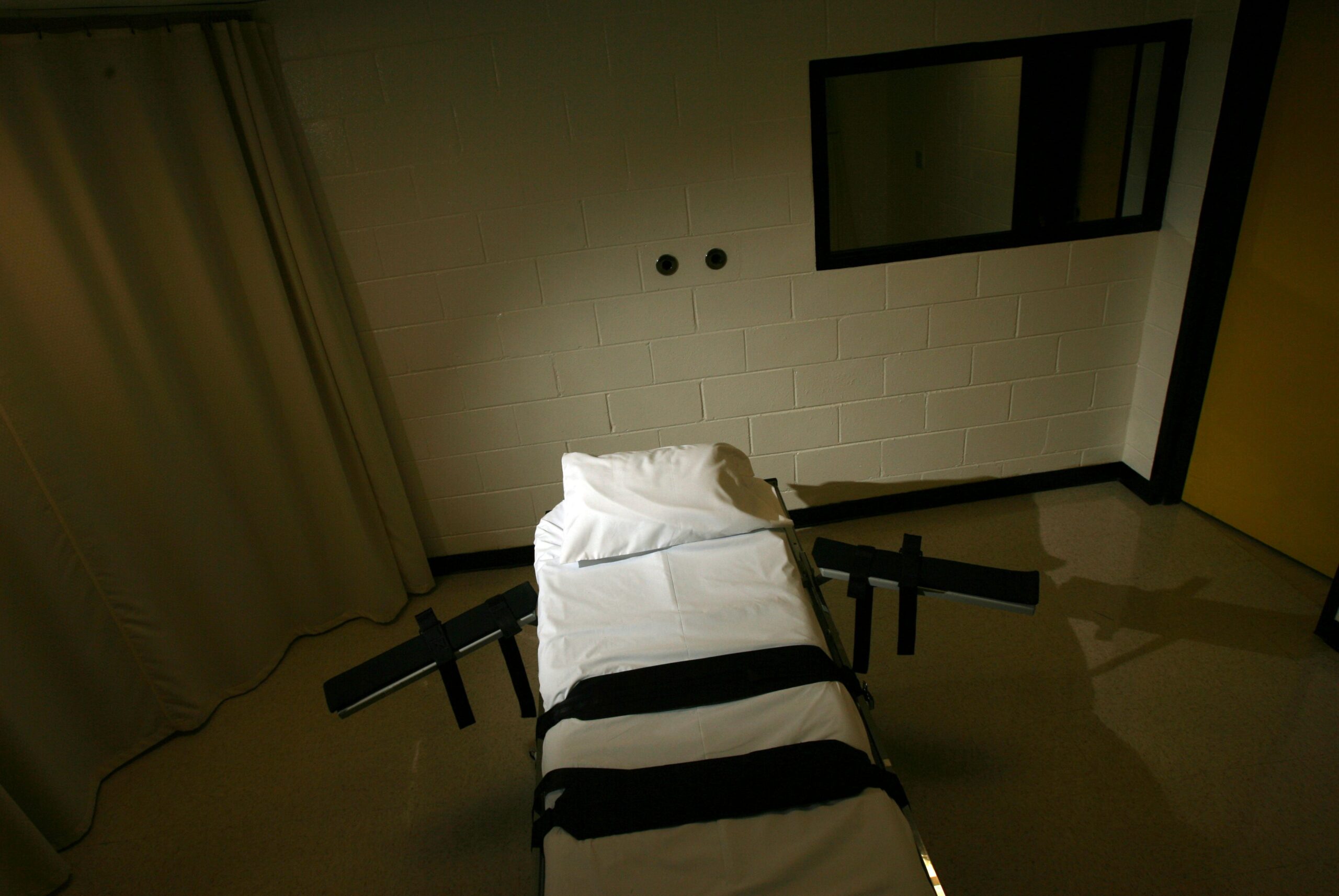 The gurney used for lethal injections sits in a small cinder block building.