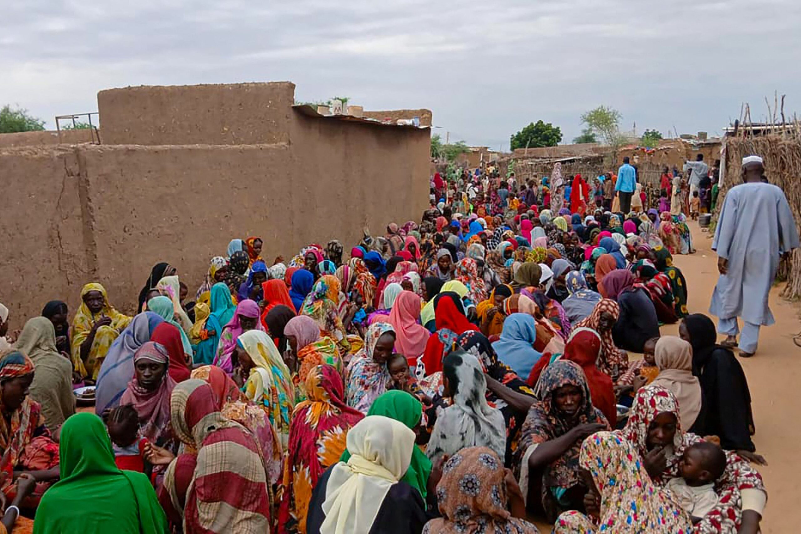 Sudanese residents gather to receive free meals in Al Fasher, a city besieged by Sudan's paramilitary Rapid Support Forces (RSF) for more than a year, in Darfur region, in August of this year. War has resulted in parts of the country being rated IPC