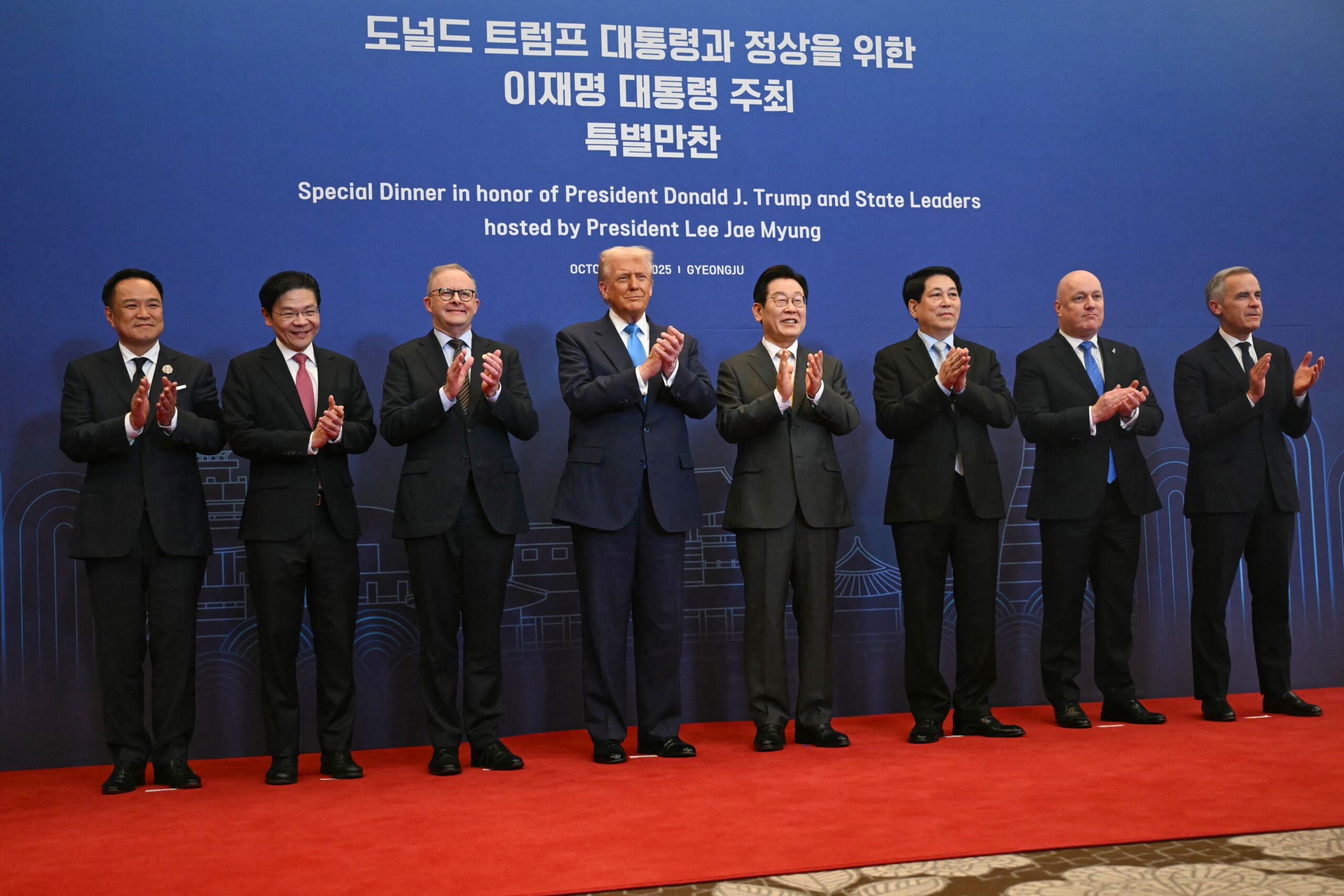 Left to right, Thailand's Prime Minister Anutin Charnvirakul, Singapore's Prime Minister Lawrence Wong, Australia's Prime Minister Anthony Albanese, President Donald Trump, South Korea's President Lee Jae Myung, Vietnam's President Luong Cuong, New Zealand's Prime Minister Christopher Luxon and Canada's Prime Minister Mark Carney pose for a photo upon their arrival for a special dinner at the Hilton Gyeongju hotel on Wednesday