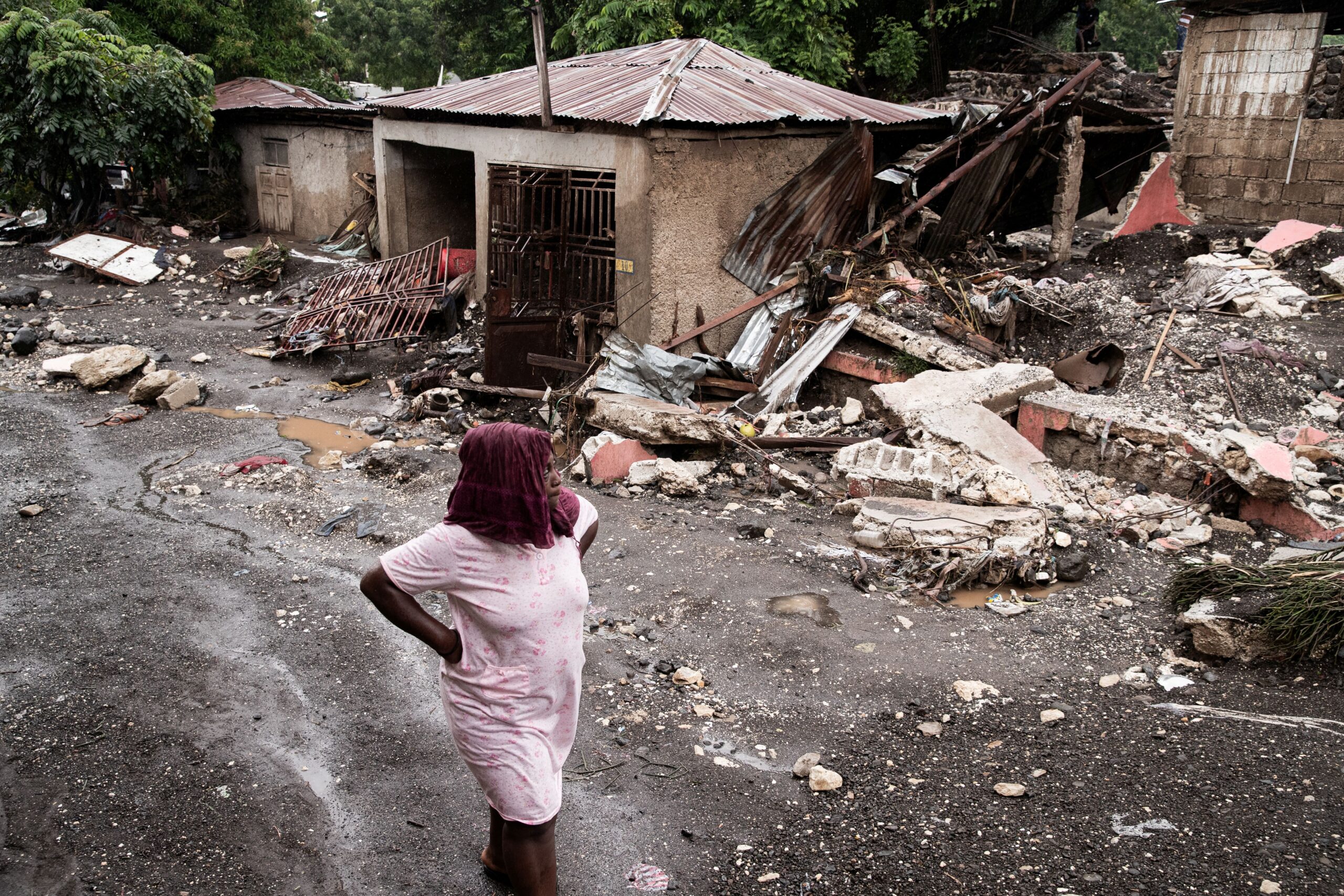 A woman walks amid rubble in Petit-Goave, Haiti, on Thursday