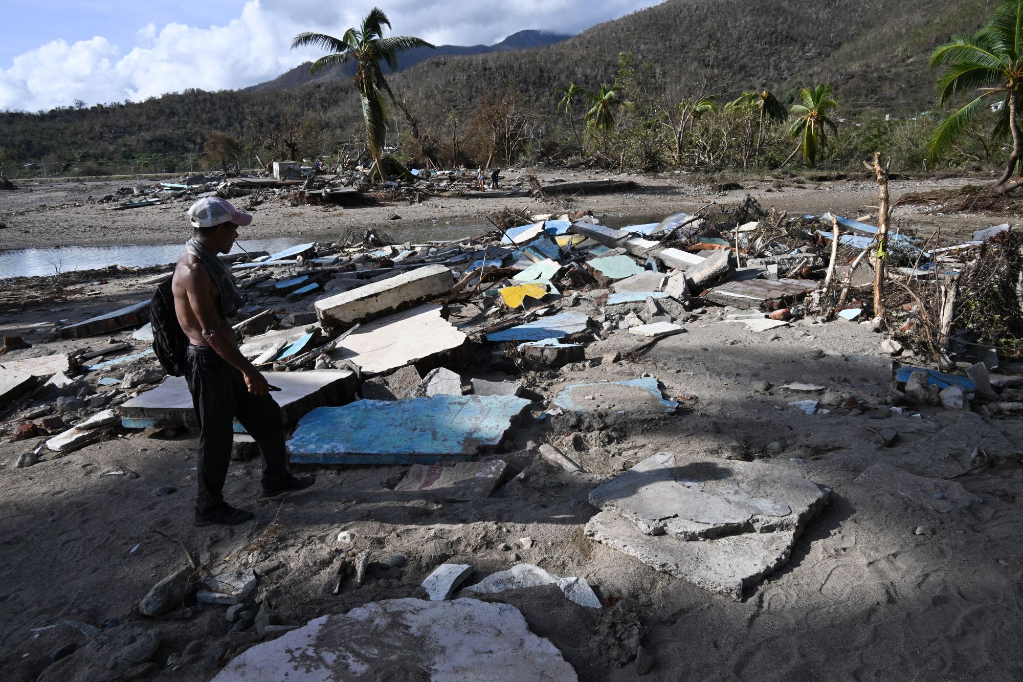 A man walks amid debris in Boca de Dos Rios village, Santiago de Cuba province, Cuba on Thursday after Hurricane Melissa devastated the region