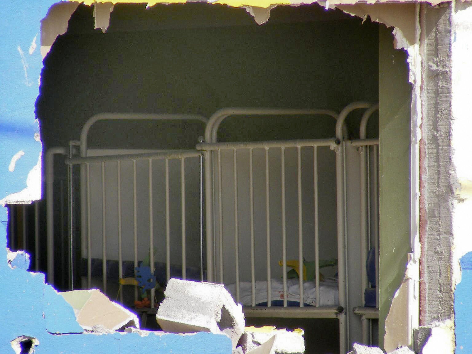 View through a hole in the wall of the interior of the ABC Daycare Center where 49 children died in a fire in Hermosillo, Mexico in 2009