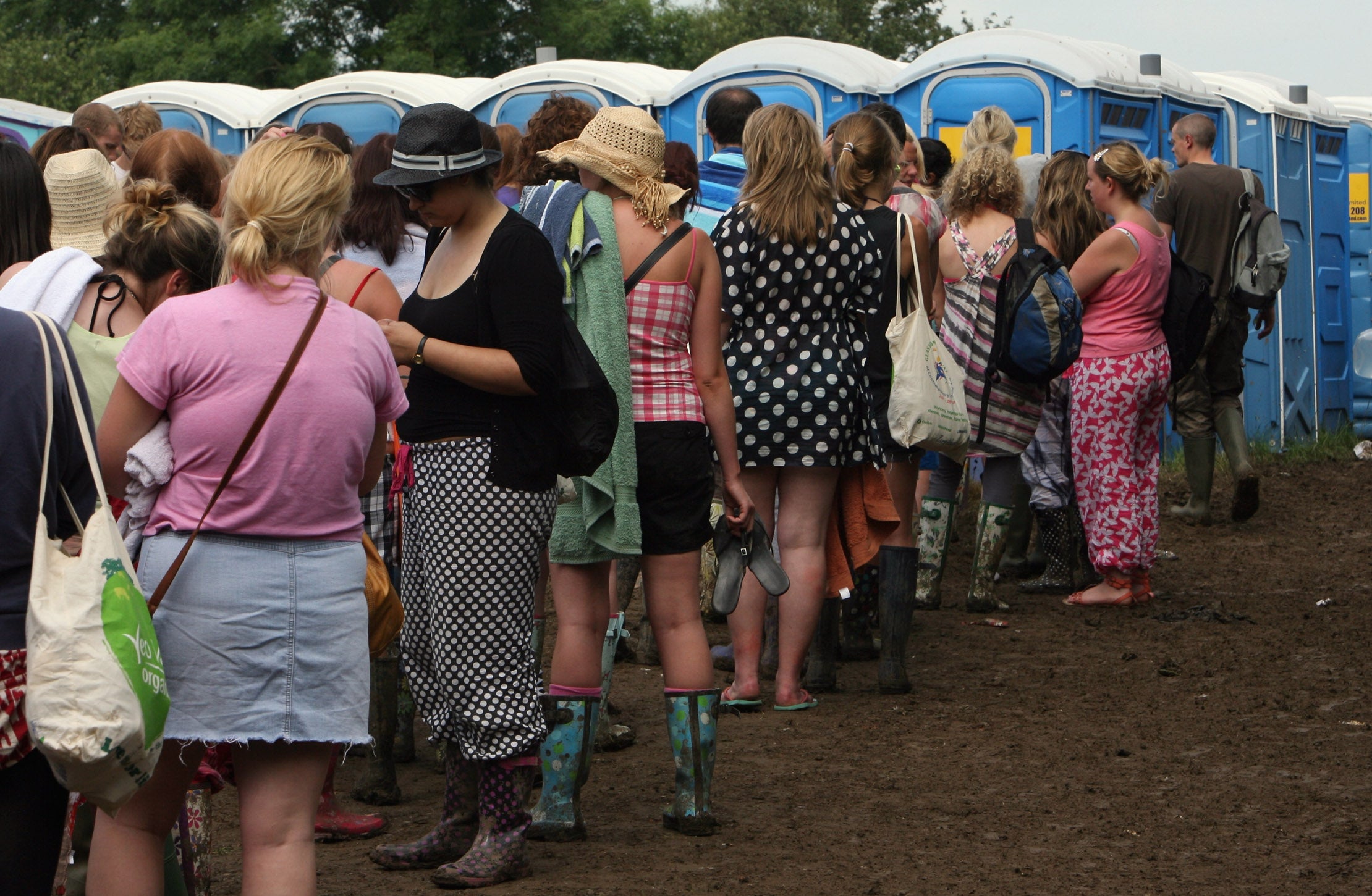Women queue for the portaloos at Glastonbury Festival