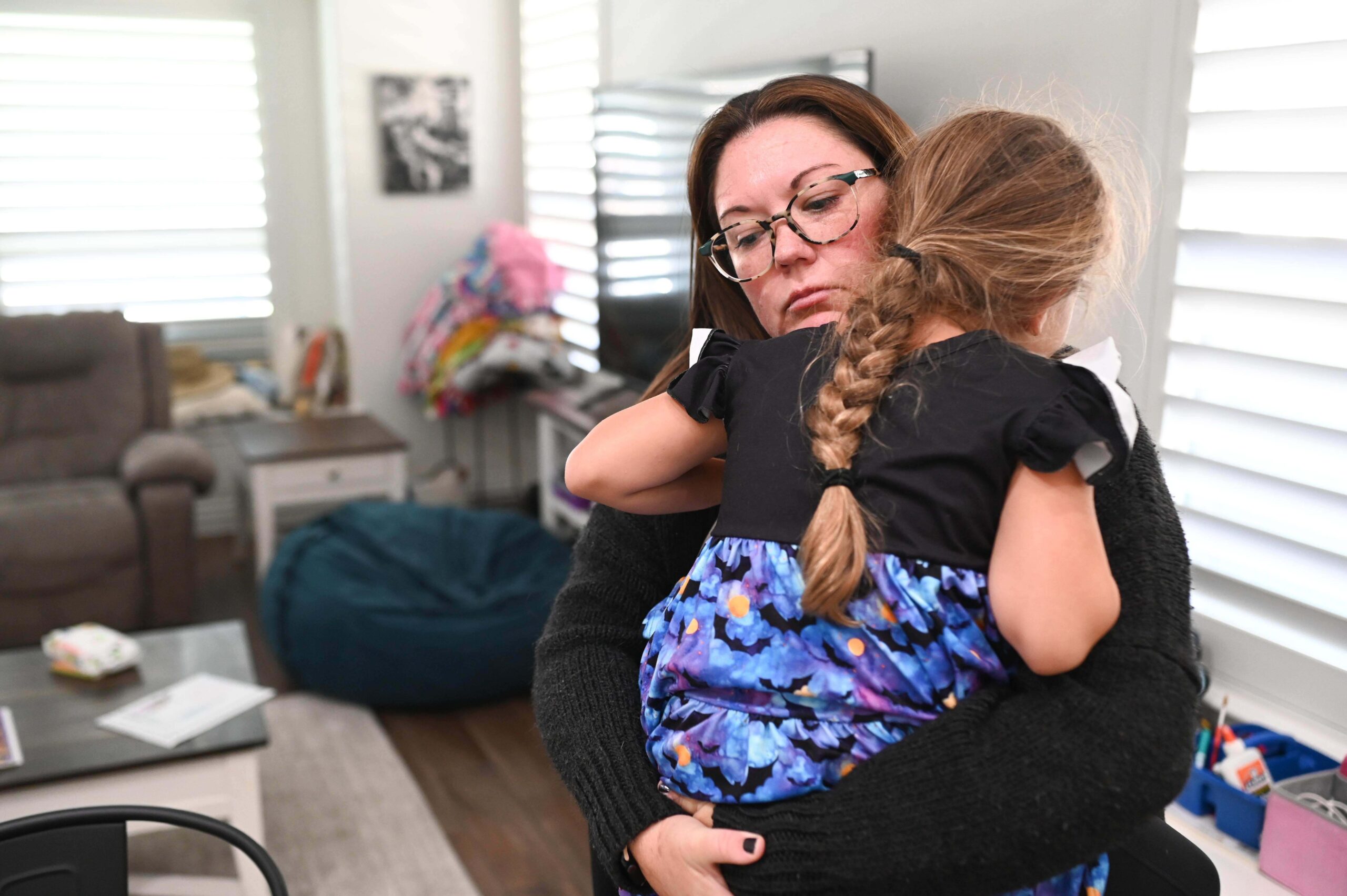 Jennifer Bittner holds her 6-year-old daughter Amelia at their home on Wednesday, Oct. 29, 2025, in Pflugerville, Texas
