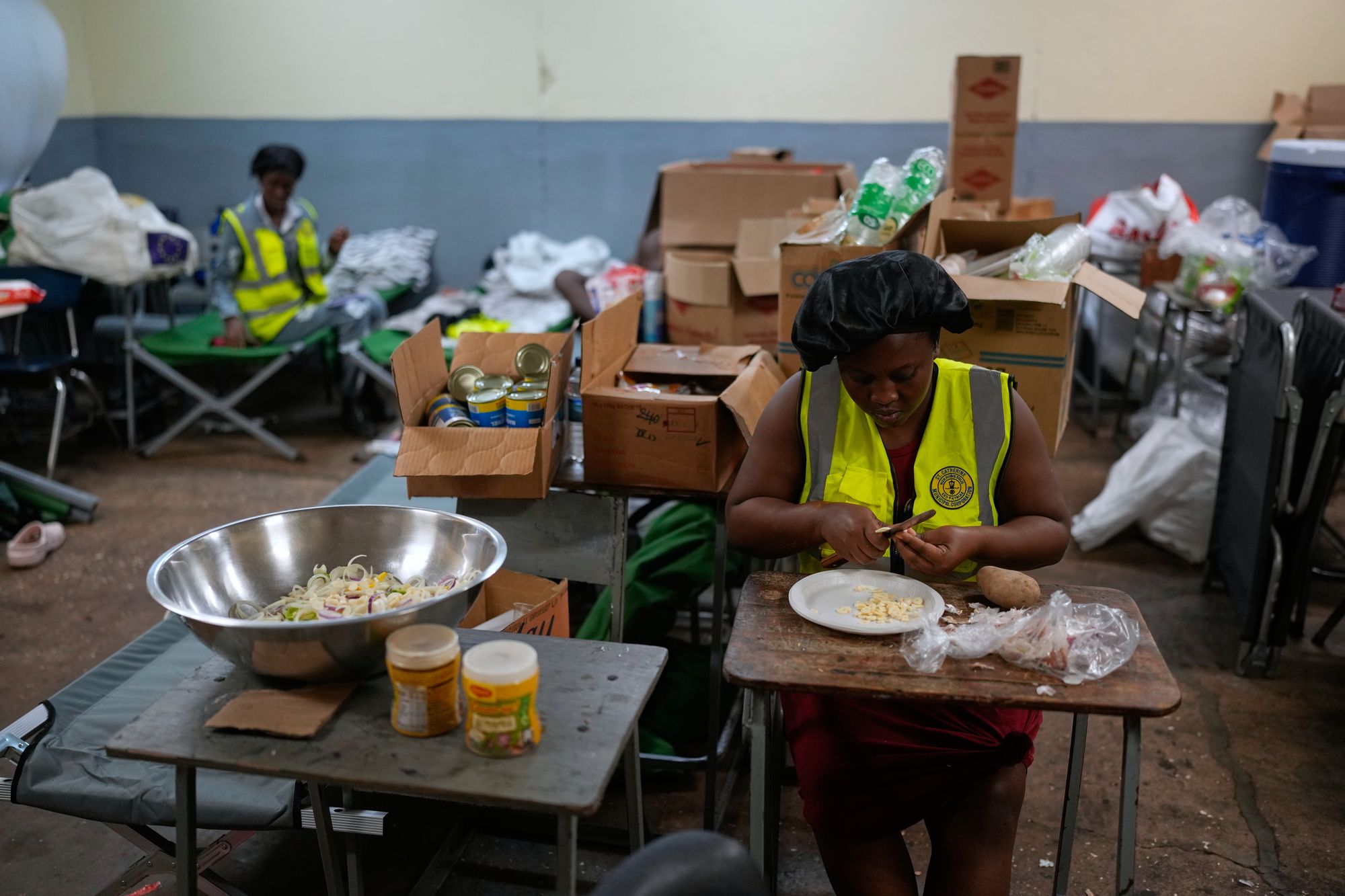 Cooks prepare meals on Monday at a shelter set up in a school ahead of Hurricane Melissa's forecast arrival in Old Harbour, Jamaica