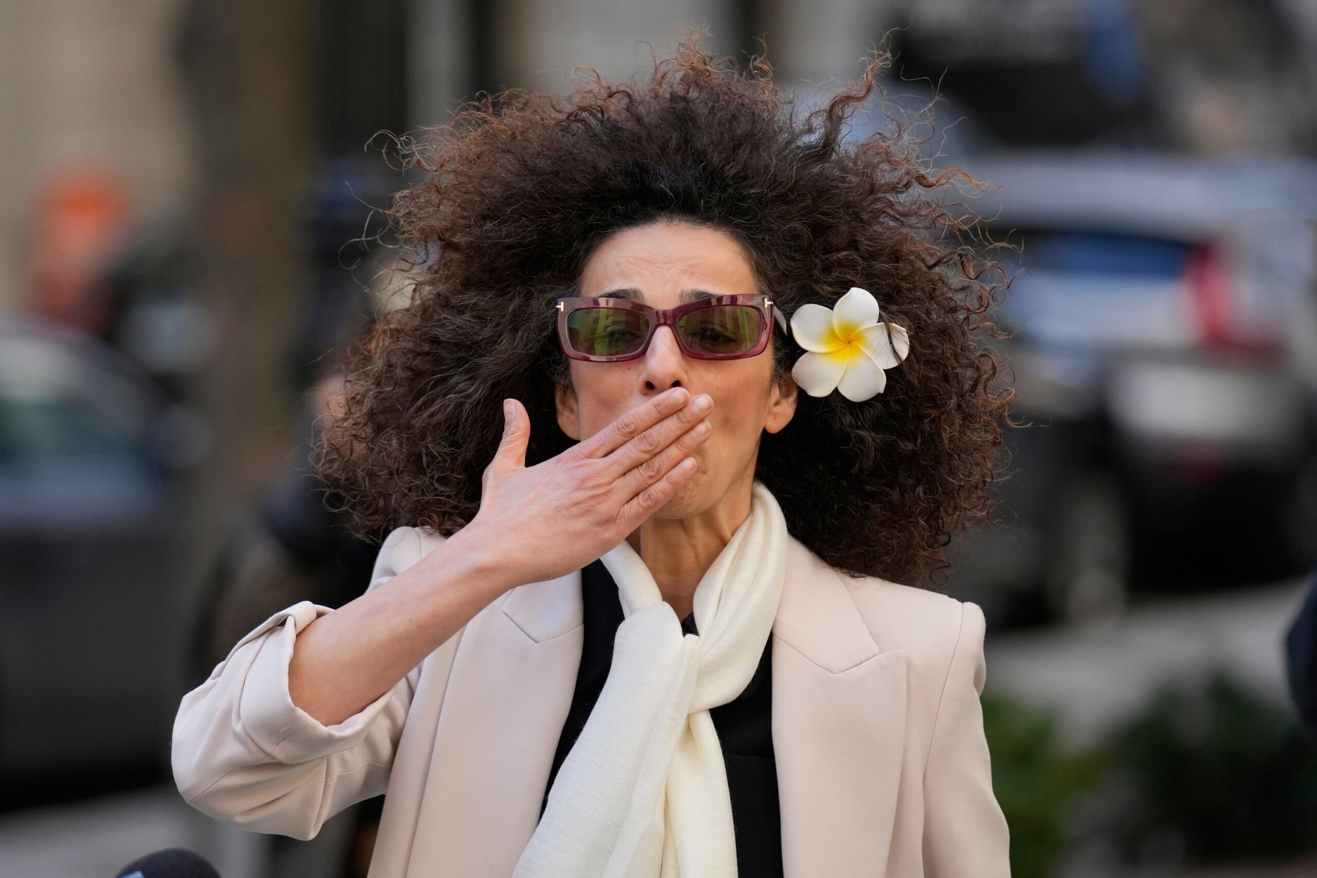 Masih Alinejad blows a kiss to supporters outside the federal courthouse after testifying at an earlier trial hearing of her would-be assassins in New York, Tuesday, March 18, 2025.