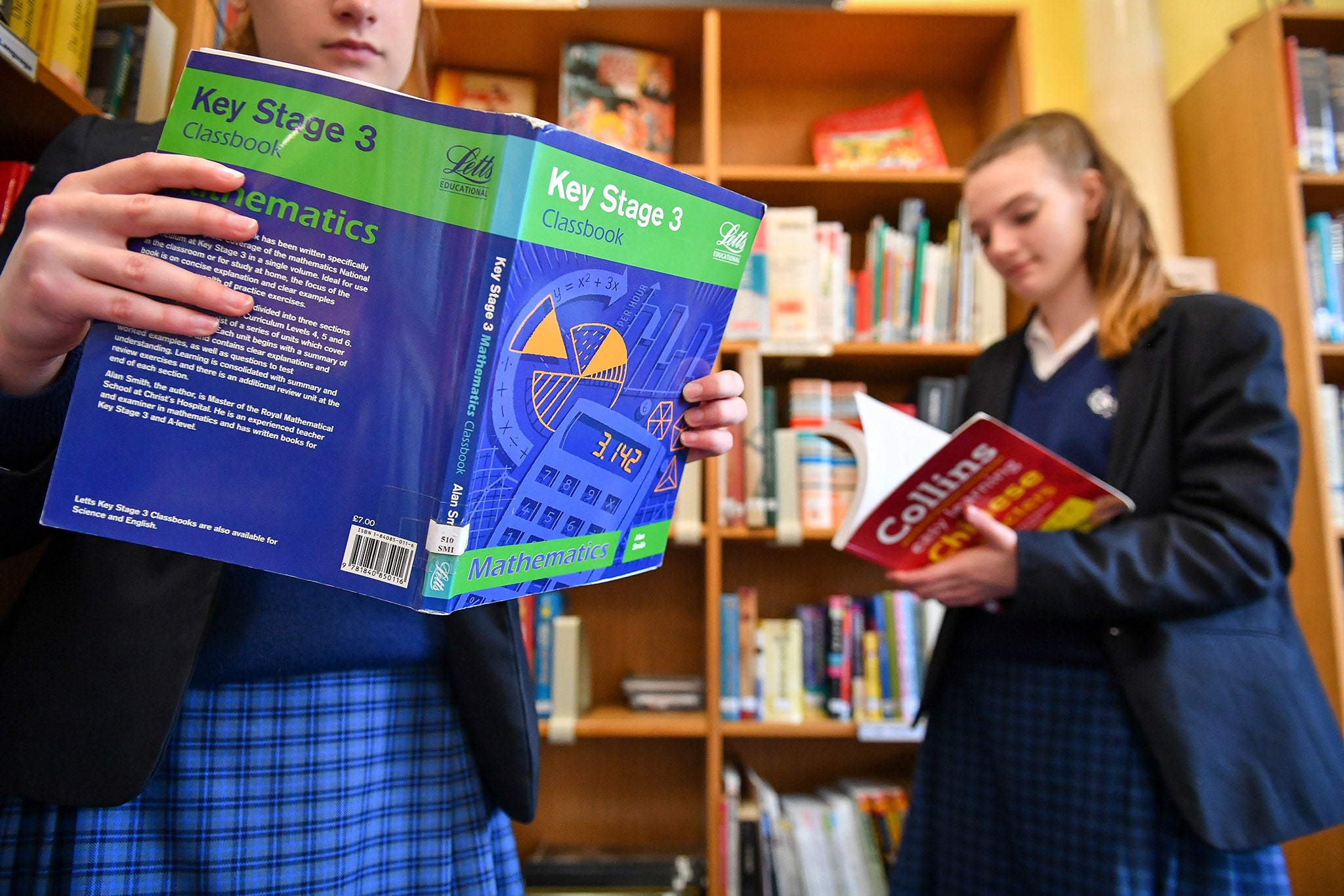 Students browse GCSE curriculum textbooks in the library at Royal High School Bath