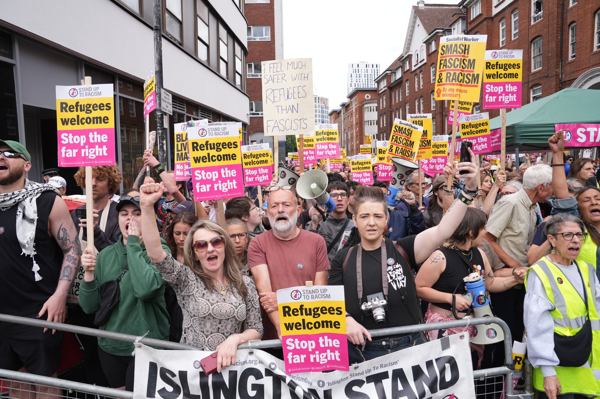 Protesters with Stand Up to Racism gather outside the Thistle City Barbican Hotel in central London, which houses asylum seekers, in August