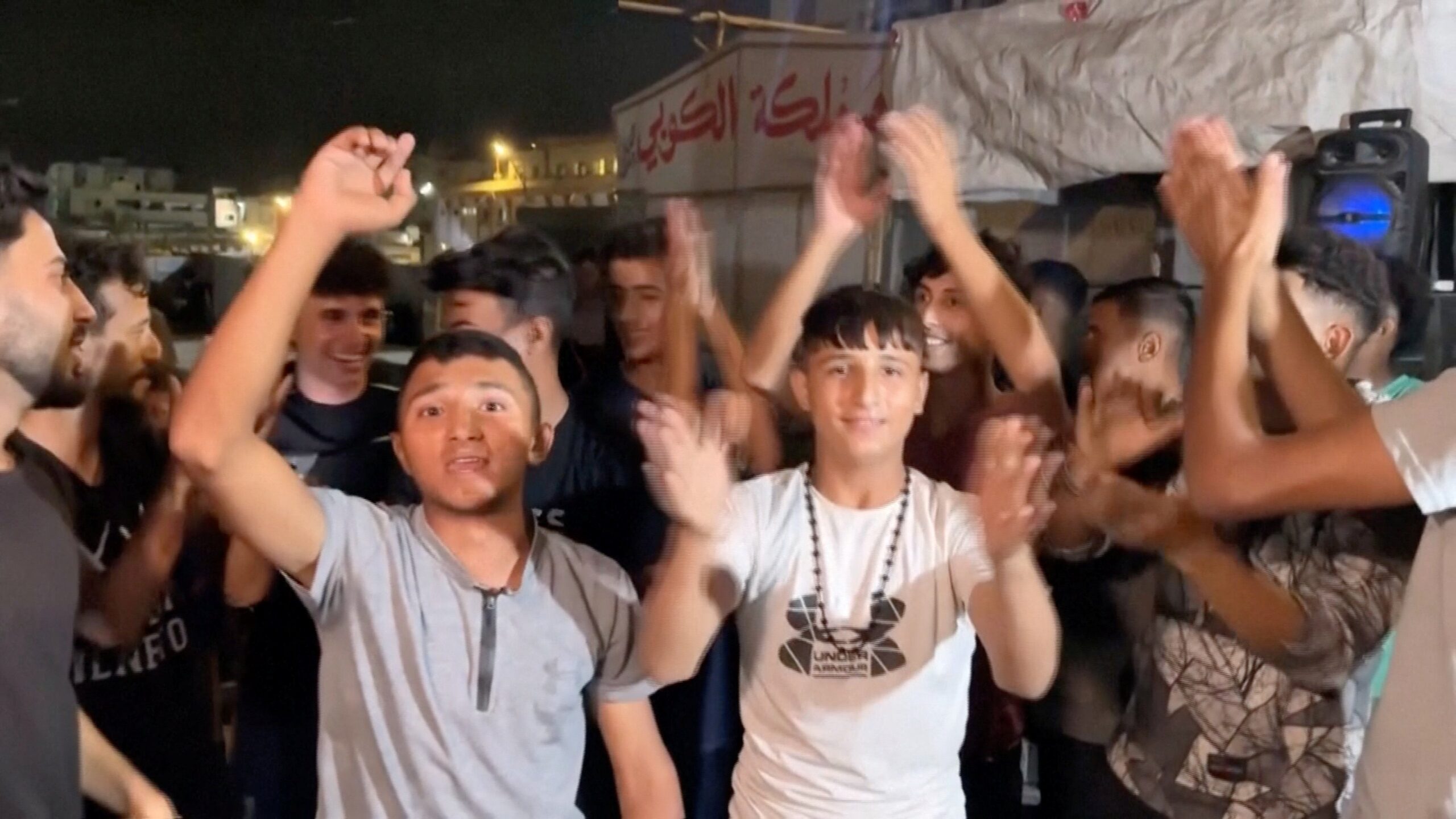 Palestinians celebrate on a street following the news that Israel and Hamas have agreed on Wednesday to the first phase of US president Donald Trump's plan for Gaza