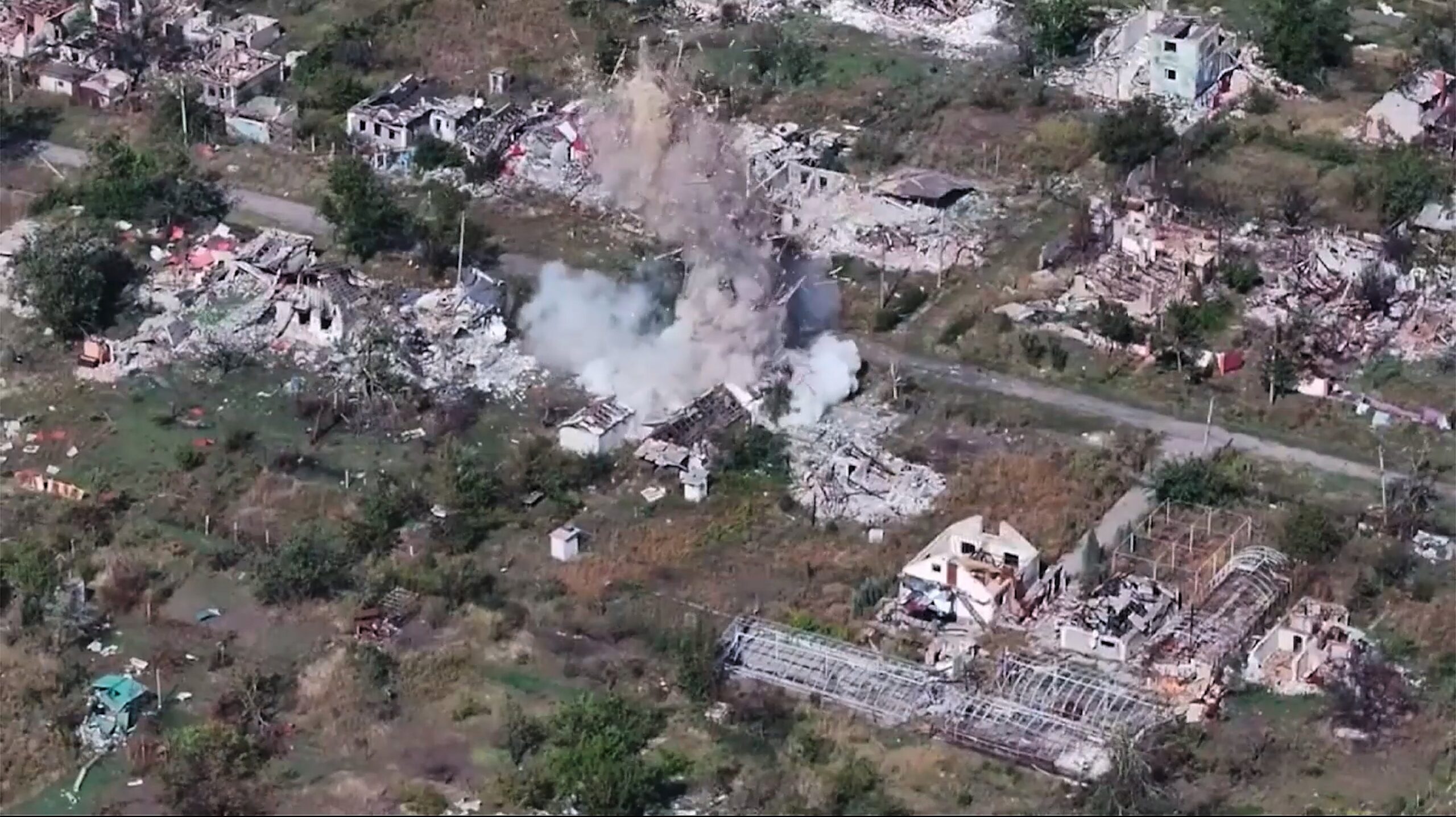 A shell explodes in a village after a Russian gun is fired on an undisclosed location in Ukraine