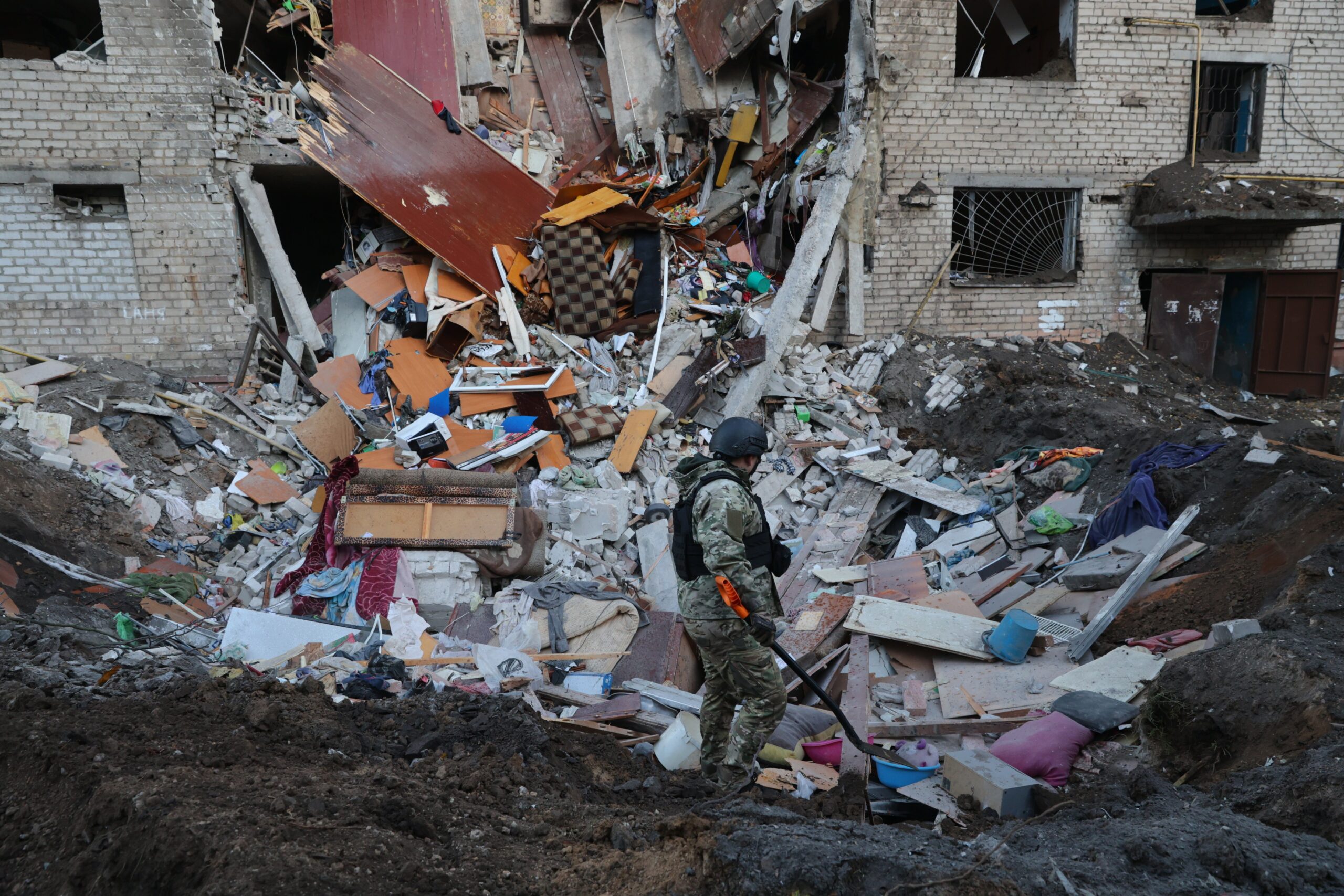 Emergency personnel examine the site of an airstrike after a Russian missile hit a hostel in Zaporizhzhia