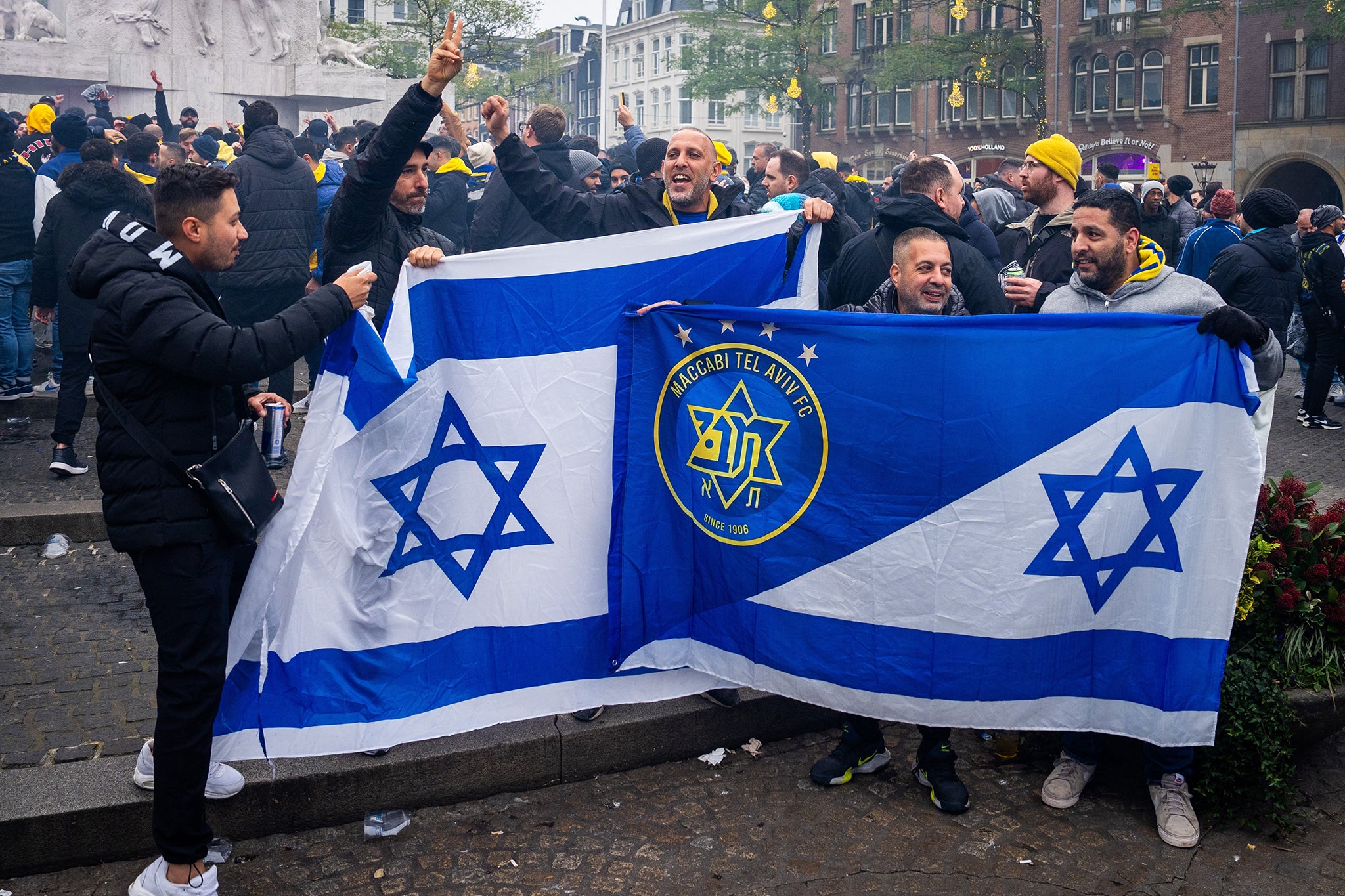 Supporters of Maccabi Tel Aviv hold flags at Dam square ahead of the match in Amsterdam