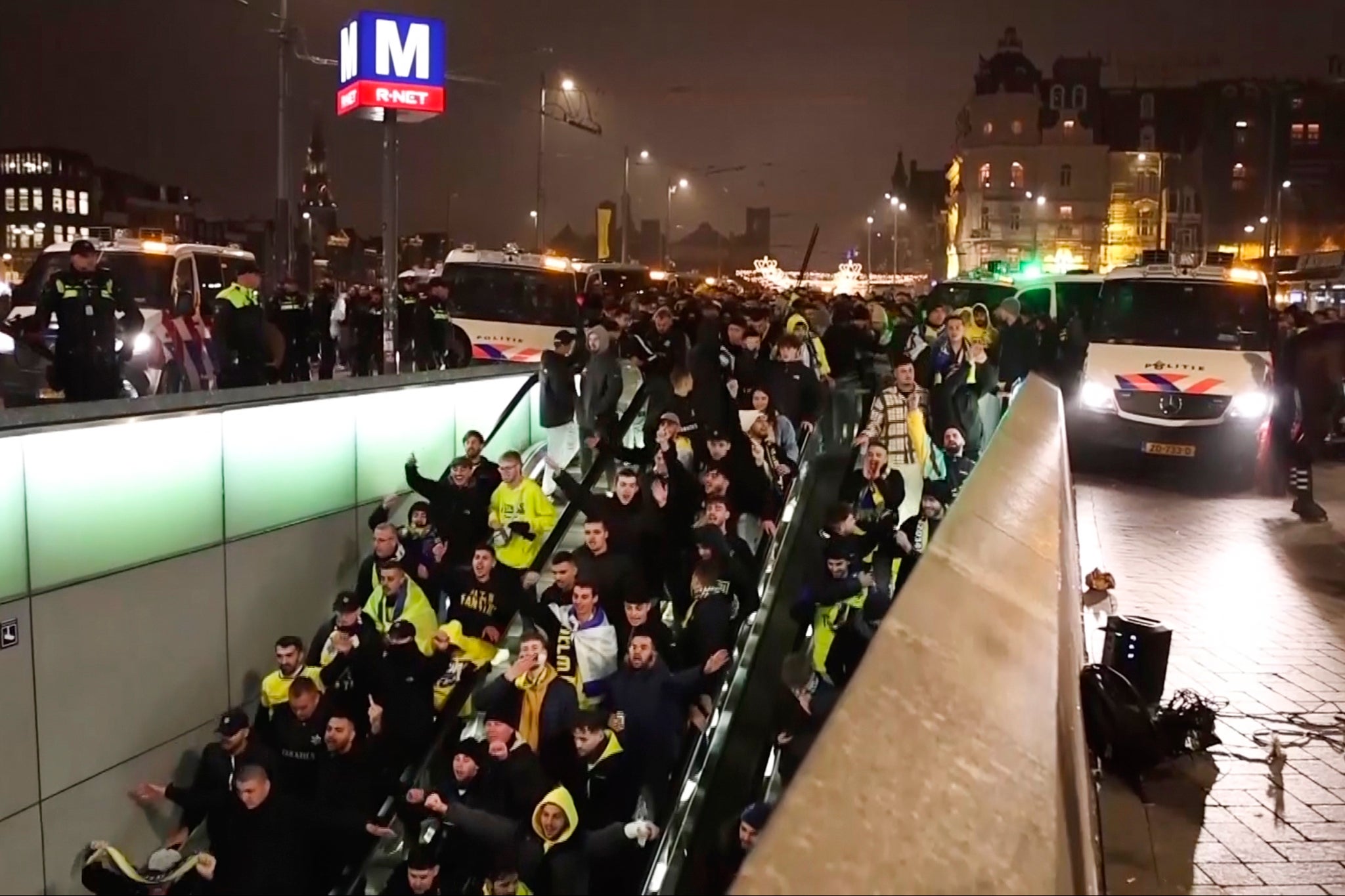Police escort Maccabi Tel Aviv supporters to the train after a pro-Palestinian march by the stadium