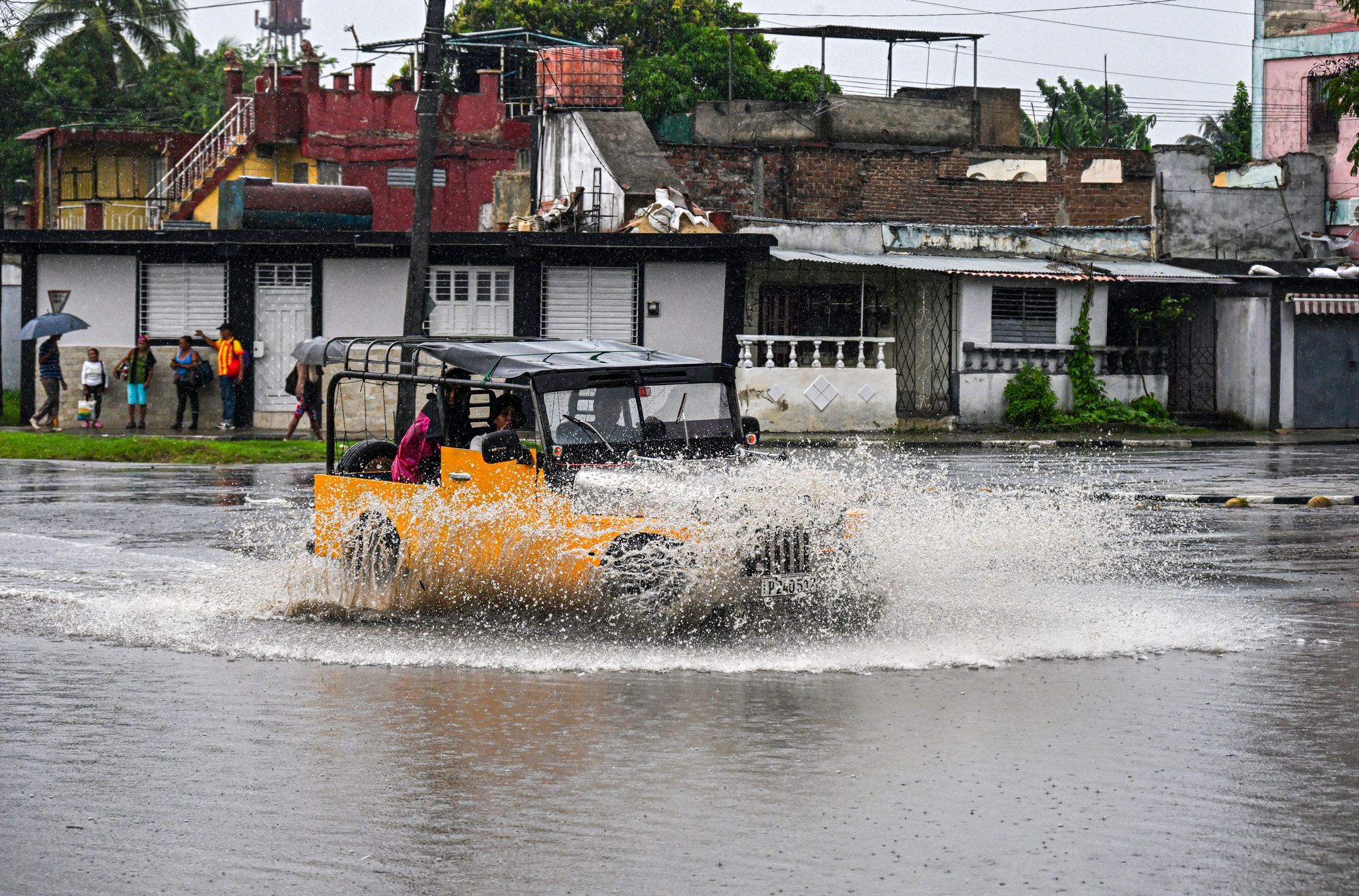 A car drives through a flooded street ahead of Hurricane Melissa's arrival in Santiago de Cuba, Cuba, on Tuesday.