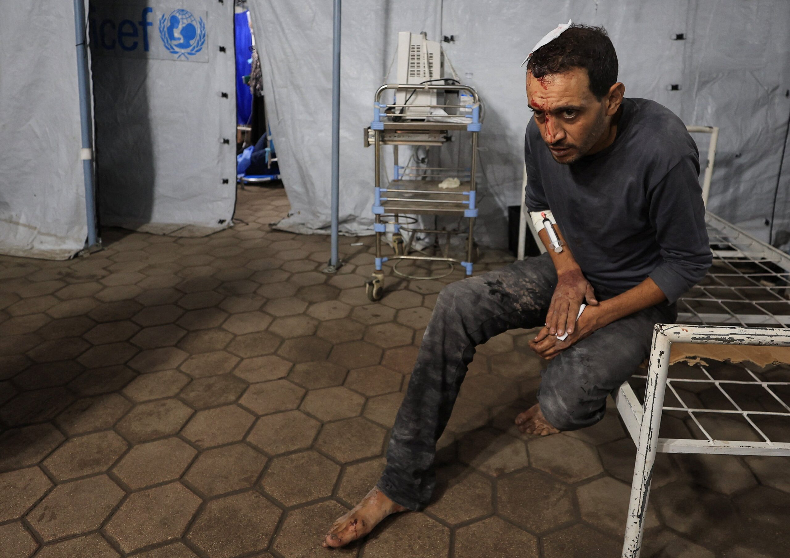 A Palestinian man receiving treatment after an Israeli attack on a house