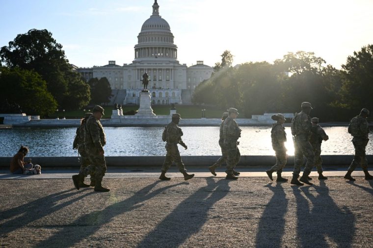 Members of the National Guard patrol along the grounds of the US Capitol on the first day of the US government shutdown in Washington, DC, on October 1, 2025. The US government began shutting down after midnight on October 1 as lawmakers and President Donald Trump failed to break a budget impasse during acrimonious talks that hinged on Democratic demands for health care funding. (Photo by Brendan SMIALOWSKI / AFP) (Photo by BRENDAN SMIALOWSKI/AFP via Getty Images)