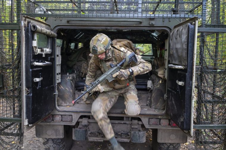 KHARKIV, UKRAINE - SEPTEMBER 30: Ukrainian soldiers conduct tactical training with a Tigr armored vehicle, a Russian 4??4 multipurpose armored vehicle for infantry mobility, near the front line in the Kharkiv region, Ukraine, on September 30, 2025. (Photo by Jose Colon/Anadolu via Getty Images)