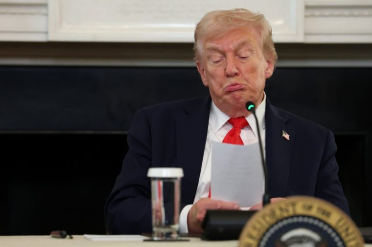 WASHINGTON, DC - OCTOBER 08: U.S. President Donald Trump reads a note handed to him by U.S. Secretary of State Marco Rubio he said was regarding Middle East peace talks during a roundtable discussion in the State Dining Room of the White House on October 08, 2025 in Washington, DC. Trump???s administration held the roundtable to discuss the anti-fascist Antifa movement after signing an executive order designating it as a ???domestic terrorist organization???. (Photo by Anna Moneymaker/Getty Images)