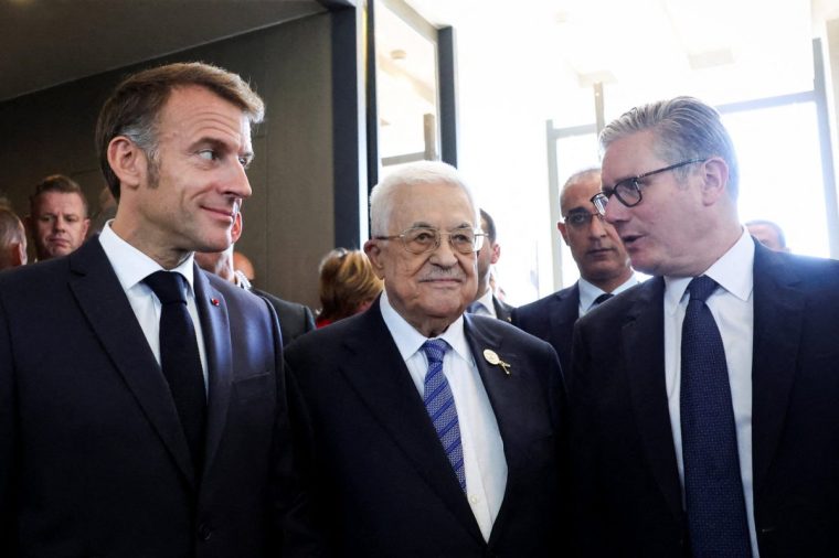 Palestinian president Mahmud Abbas (C) speaks with Britain's Prime Minister Keir Starmer (R) and France's President Emmanuel Macron (L) upon arrival at the congress centre to attend the Sharm El-Sheikh Peace Summit, in the Egyptian Red Sea resort town of Sharm el-Sheikh, on October 13, 2025. Trump and Sisi will chair the Gaza summit of more than 20 world leaders on October 13, 2025 in Egypt's Sharm El-Sheikh. Among those expected to attend are UN Secretary-General Antonio Guterres, Jordan's King Abdullah II, Britain's Prime Minister Keir Starmer, France's President Emmanuel Macron and his Turkey's counterpart Recep Tayyip Erdogan. Canada will also be represented by its Prime Minister Mark Carney. (Photo by Suzanne Plunkett / POOL / AFP) (Photo by SUZANNE PLUNKETT/POOL/AFP via Getty Images)