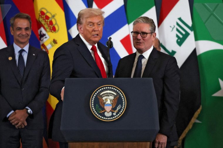 U.S. President Donald Trump (R) and British Prime Minister Keir Starmer speak as they pose for a photo at the Gaza summit in Sharm El-Sheikh on October 13, 2025. Trump landed in Egypt on October 13 for a summit on Gaza, following a lightning visit to Israel after a ceasefire he brokered entered into force. (Photo by Suzanne Plunkett / POOL / AFP) (Photo by SUZANNE PLUNKETT/POOL/AFP via Getty Images)