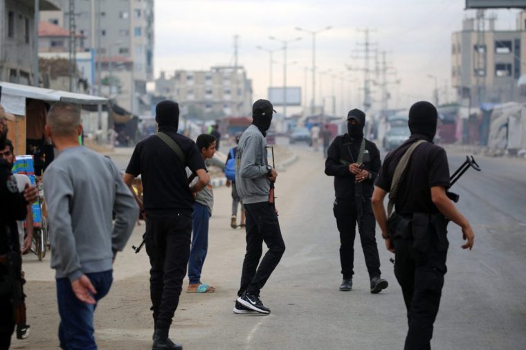 Members of the internal security forces loyal to the Palestinian group Hamas, man a checkpoint in the Nuseirat refugee camp in the central Gaza Strip, on October 12, 2025. Israel declared a ceasefire in Gaza and began to pull back its forces on October 10, as tens of thousands of exhausted Palestinians made their way back to their devastated homes. (Photo by Eyad BABA / AFP) (Photo by EYAD BABA/AFP via Getty Images)