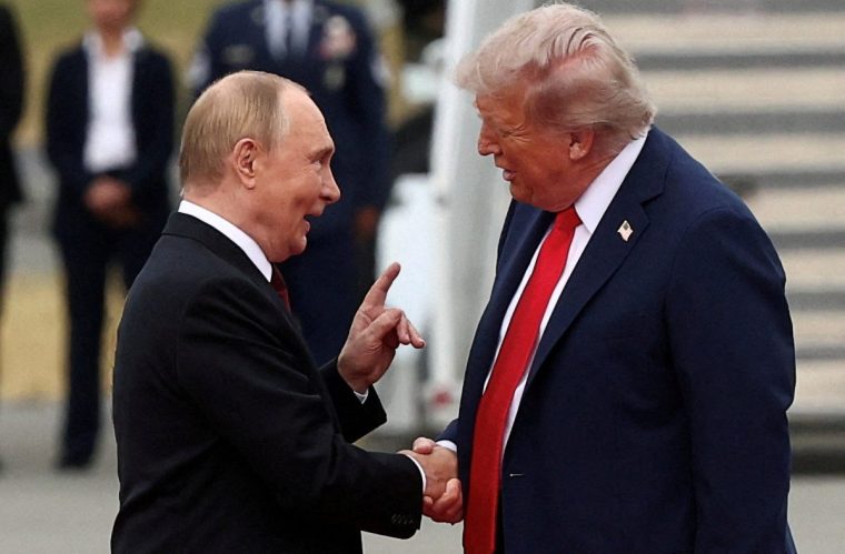 FILE PHOTO: U.S. President Donald Trump shakes hand with Russian President Vladimir Putin, as they meet to negotiate for an end to the war in Ukraine, at Joint Base Elmendorf-Richardson in Anchorage, Alaska, U.S., August 15, 2025. REUTERS/Kevin Lamarque TPX IMAGES OF THE DAY/File Photo